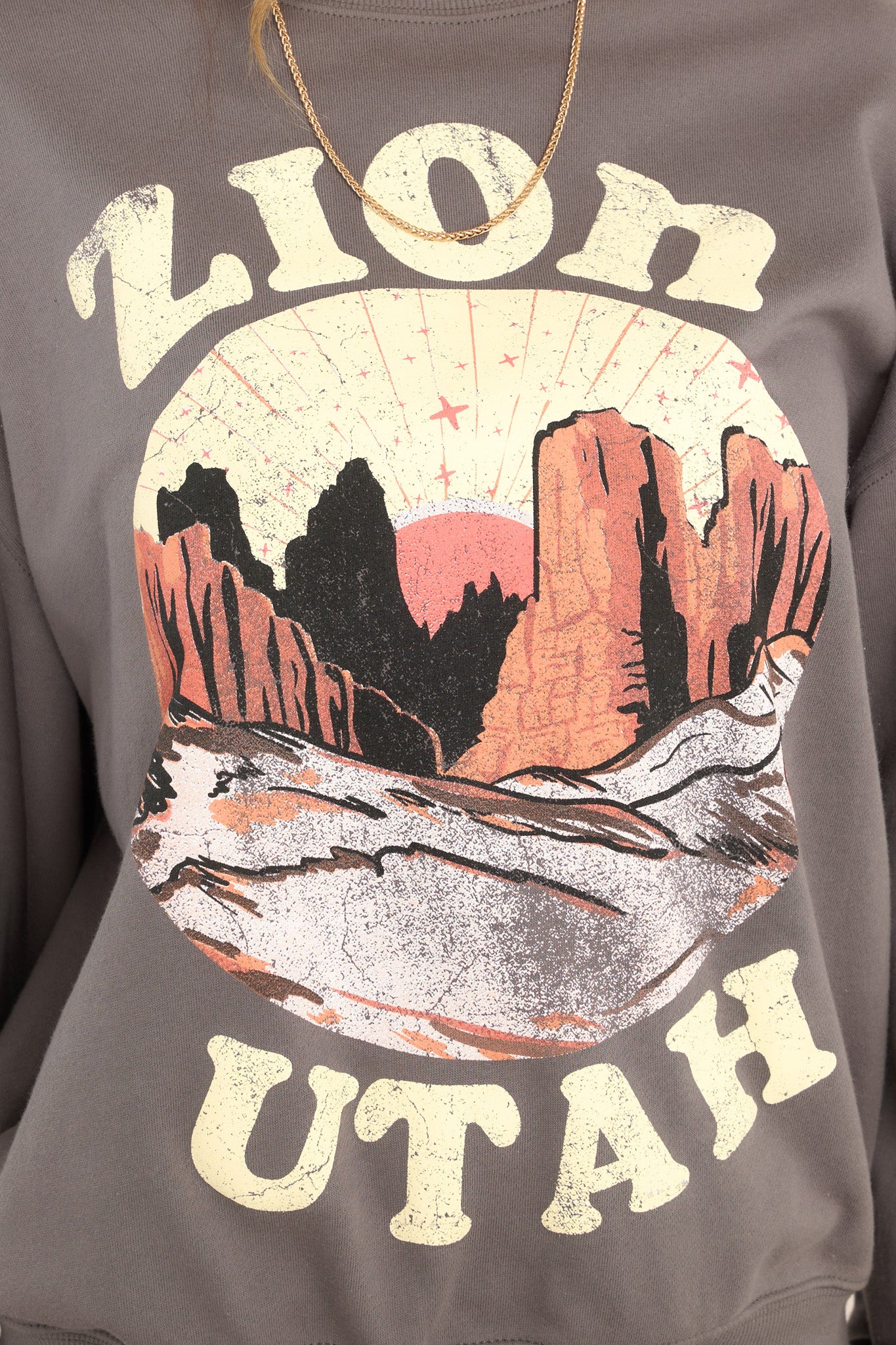 Close up view of this sweatshirt that features a graphic that says "ZION UTAH."