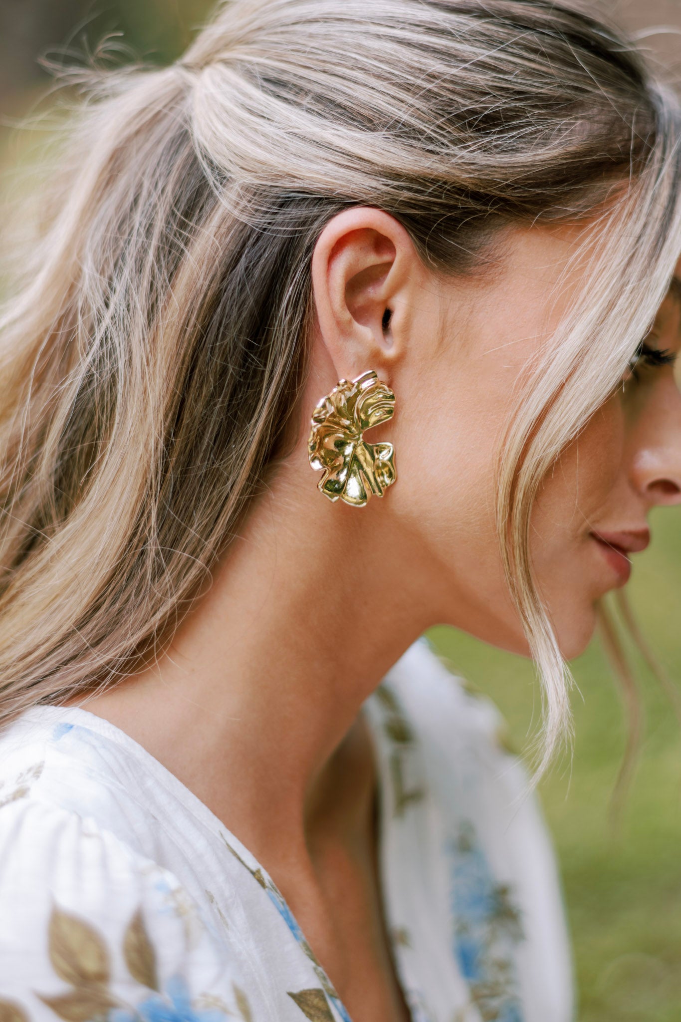 Close up of these earrings that feature gold hardware and a secure posts backing.