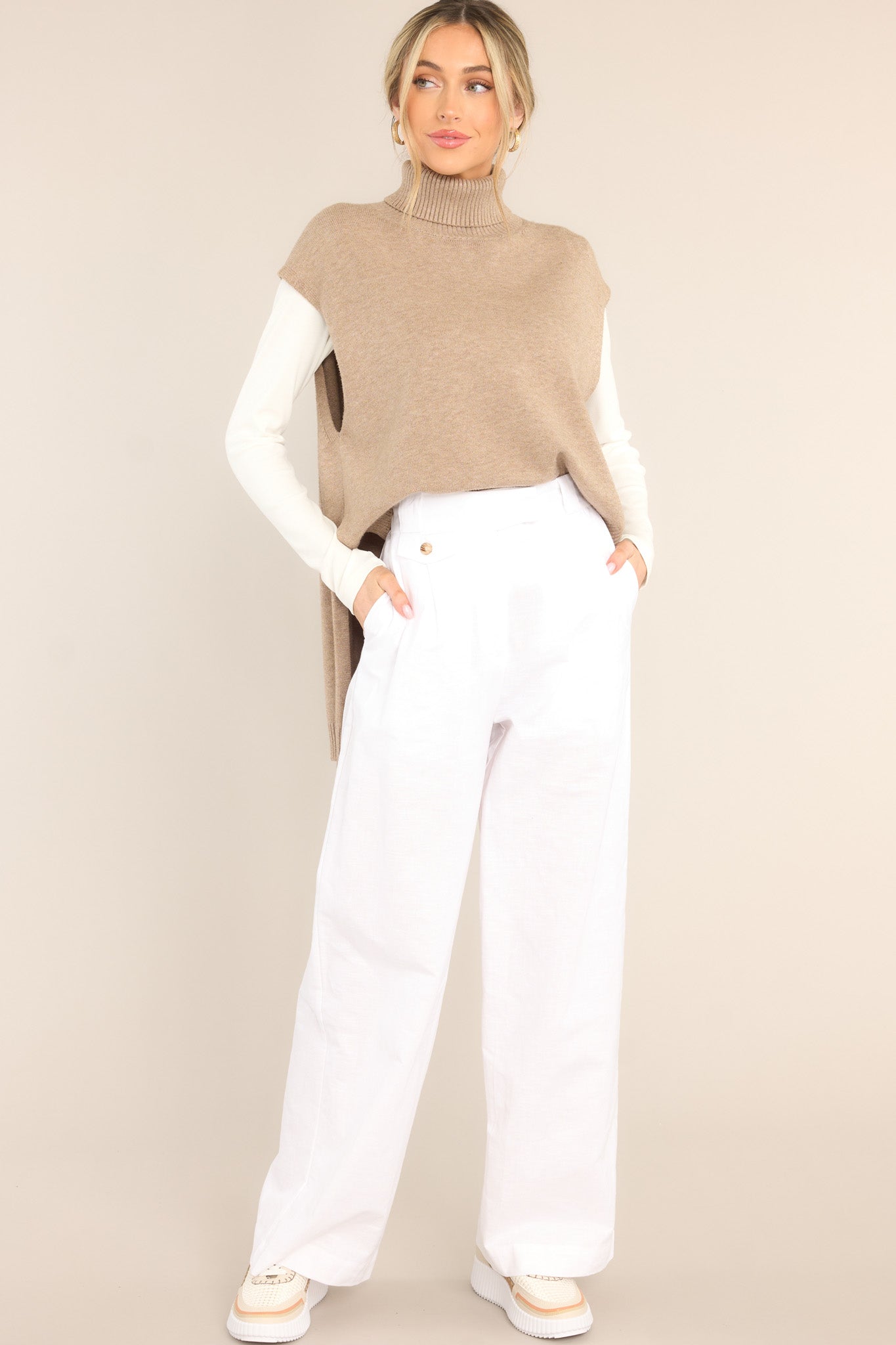 Full body view of this sweater vest that features a relaxed-fit, turtleneck, rib-knit fabric throughout, slits at sides of hem and longer at back.