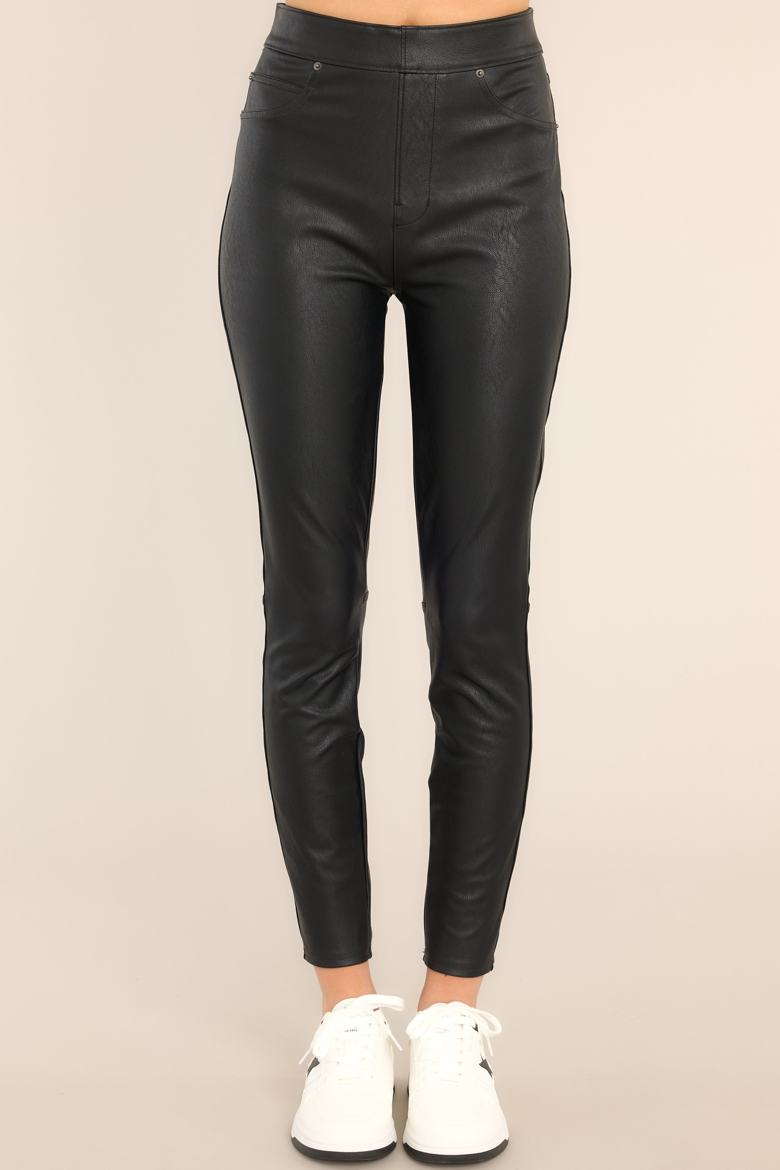 Front view of these pants that feature a high waisted pull-on design, an elastic waistband with hidden core shaping technology, faux front pockets, and functional back pockets. 