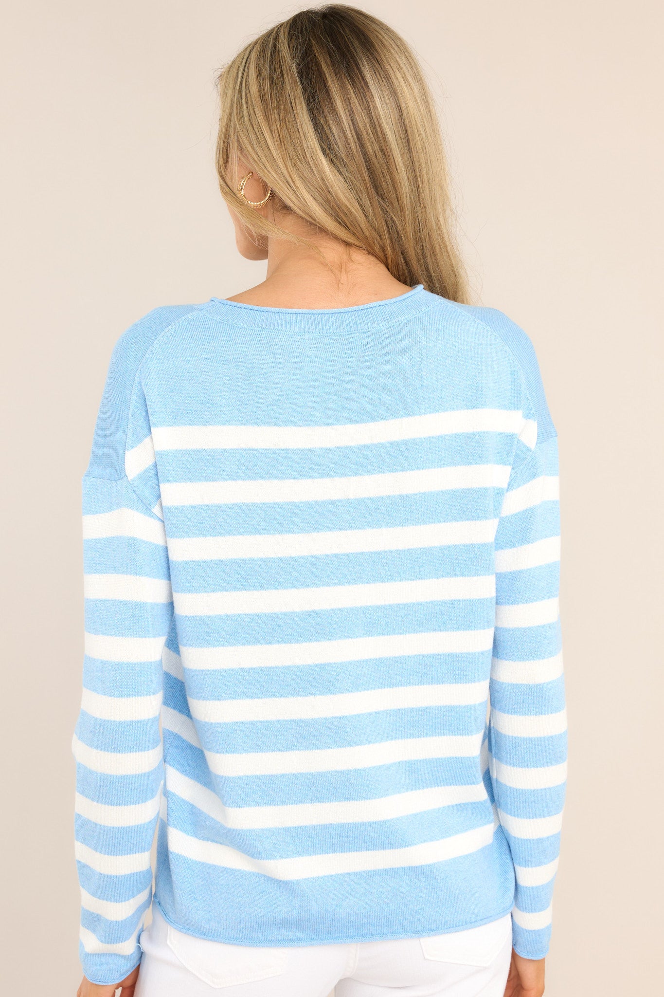 Back view of this sweater that features a ribbed crew neckline, dropped shoulders, a super soft material, and cuffed long sleeves.