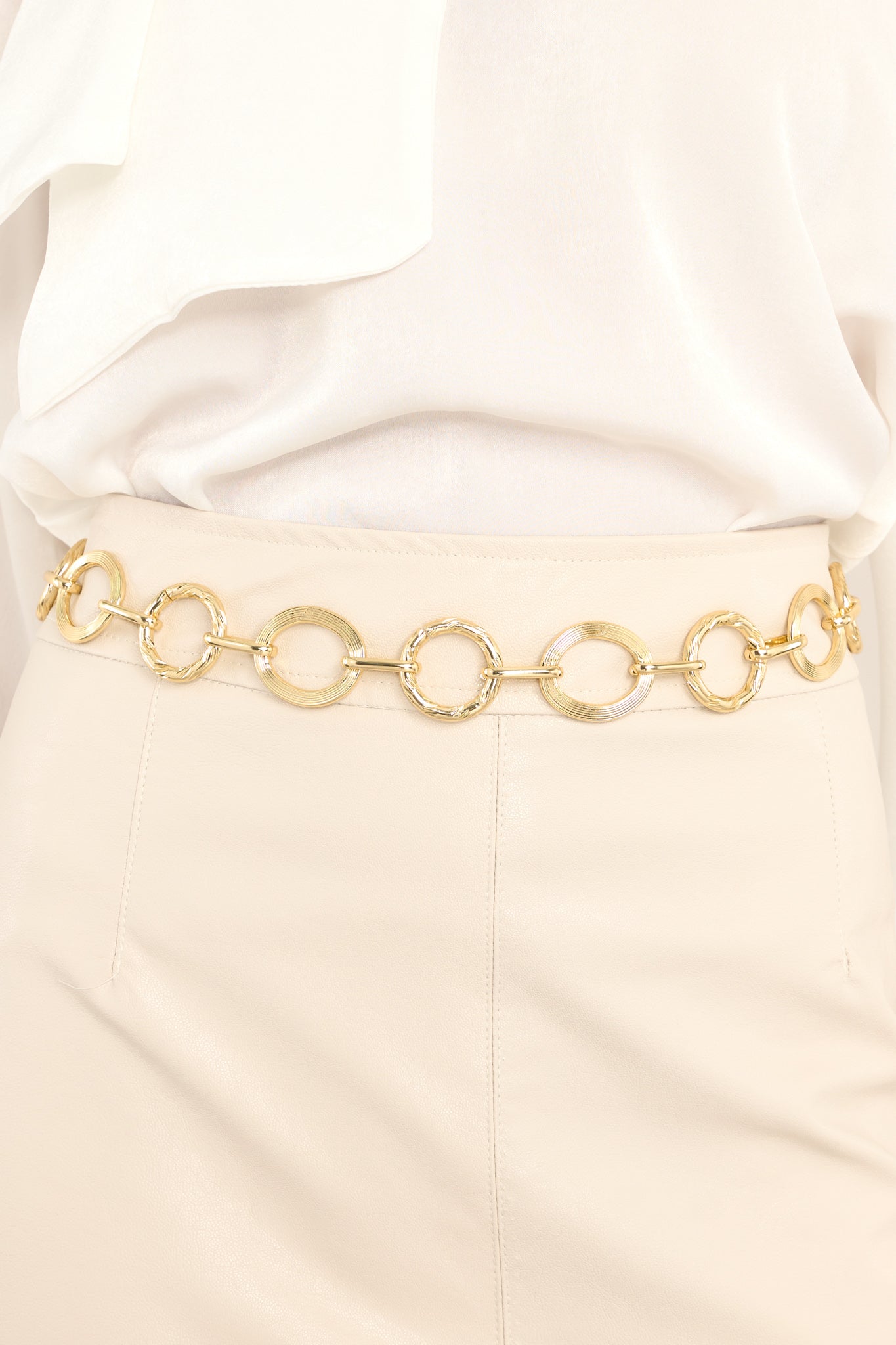 Close up view of this chain belt features links of different textures and sizes, and a lobster claw closure.