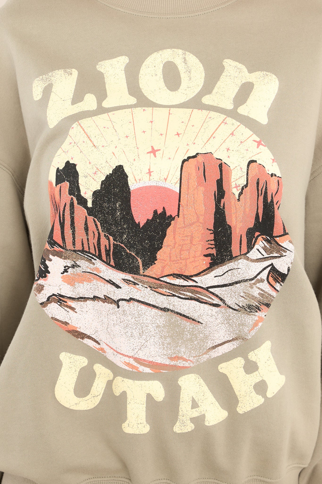 Close up view of this sweatshirt that features a graphic that says "ZION UTAH."