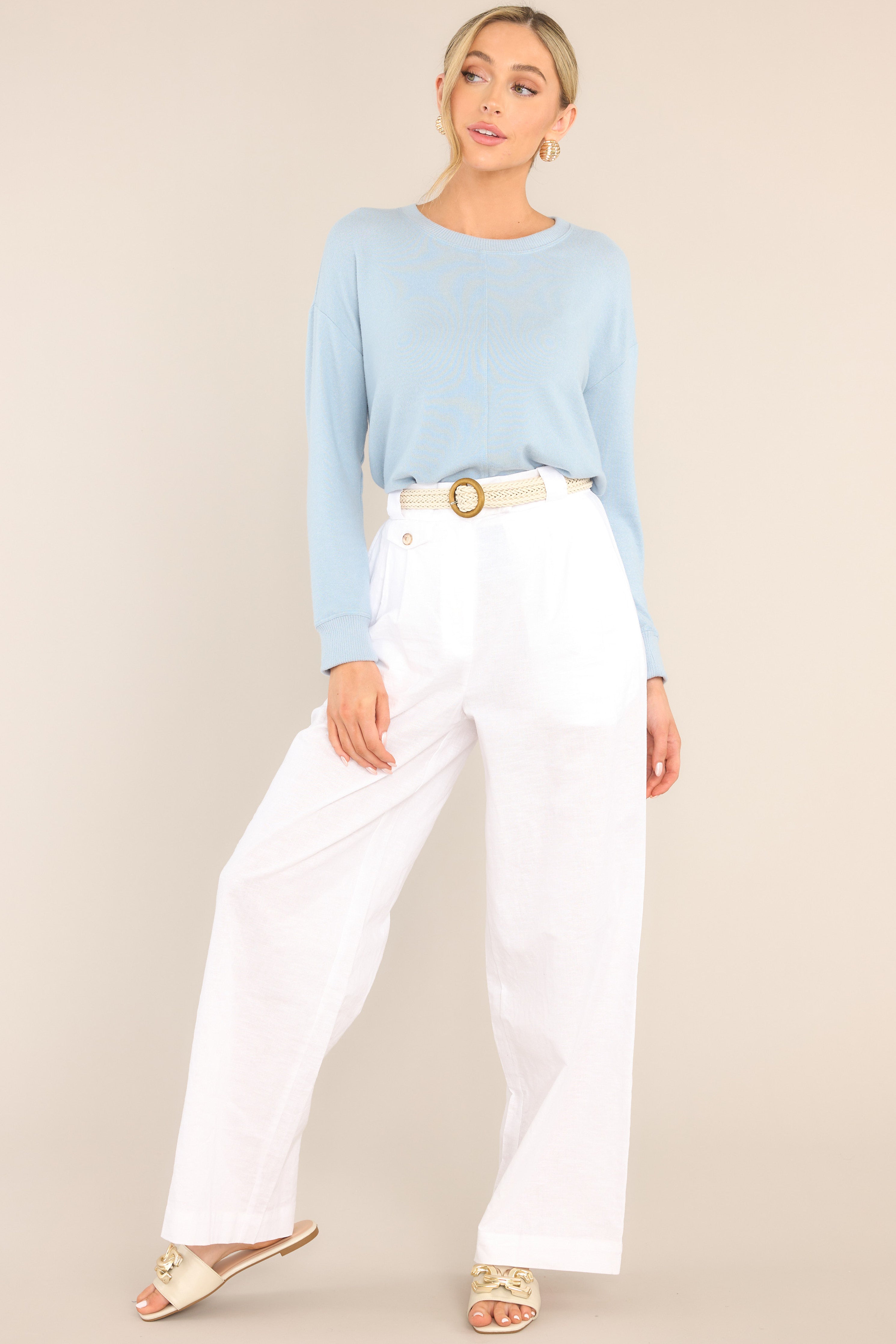 Full body view of this top that features a ribbed crew neckline, an exposed seam down the middle, ribbed cuffed long sleeves, and a ribbed split hemline.