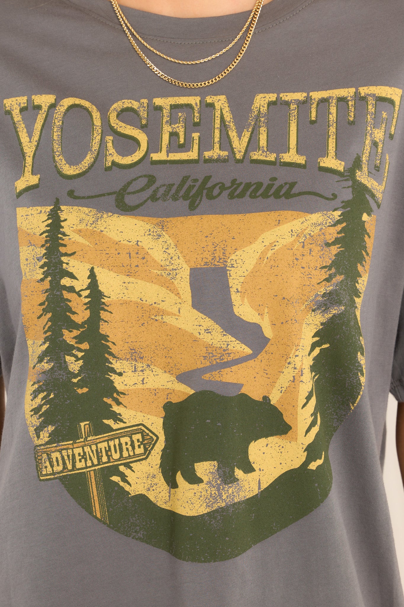 Close up view of this top that features a mountain graphic that says "YOSEMITE", "California", and "ADVENTURE."