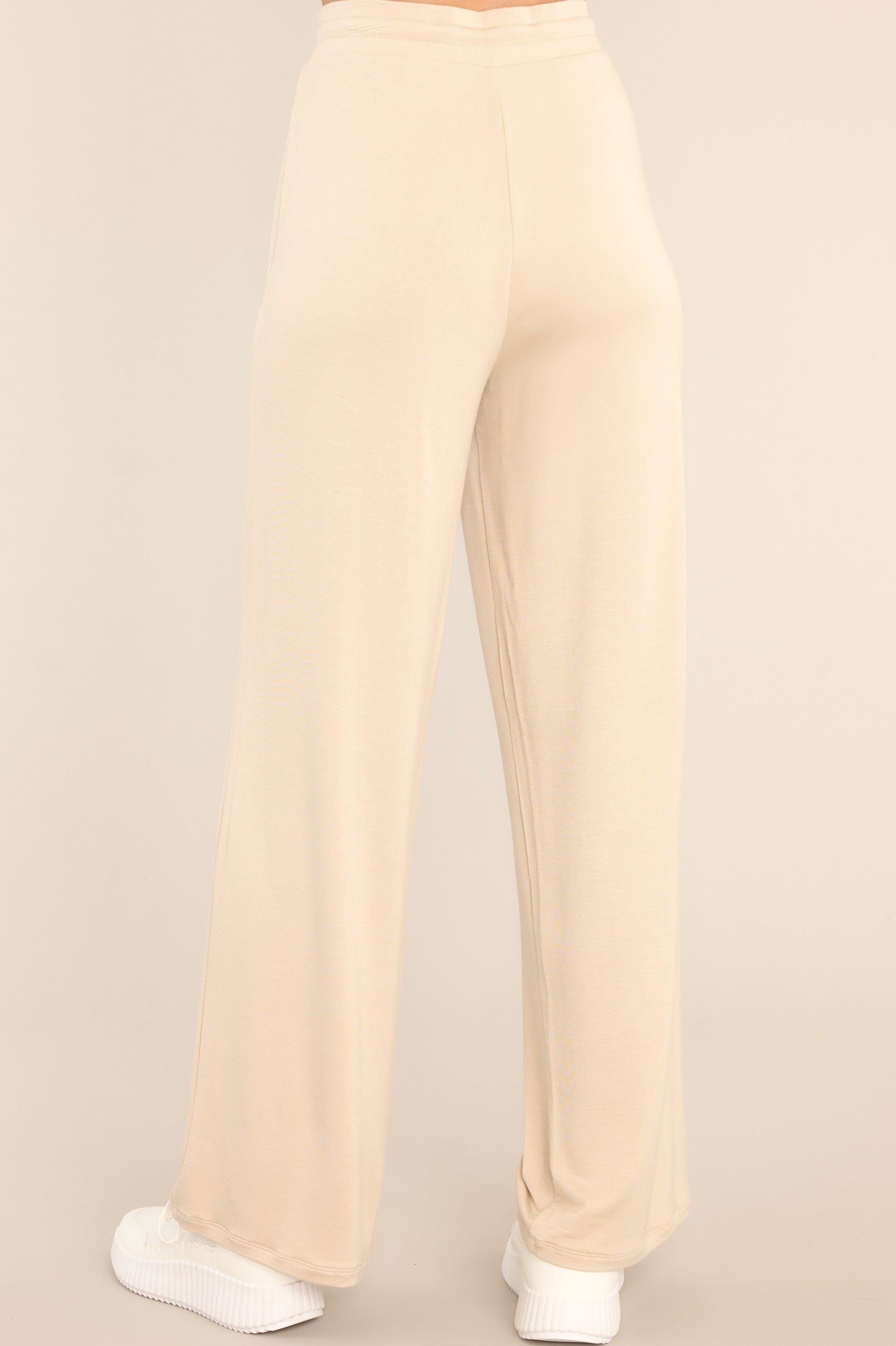 Back view of these pants that feature a high waisted design and a wide leg.