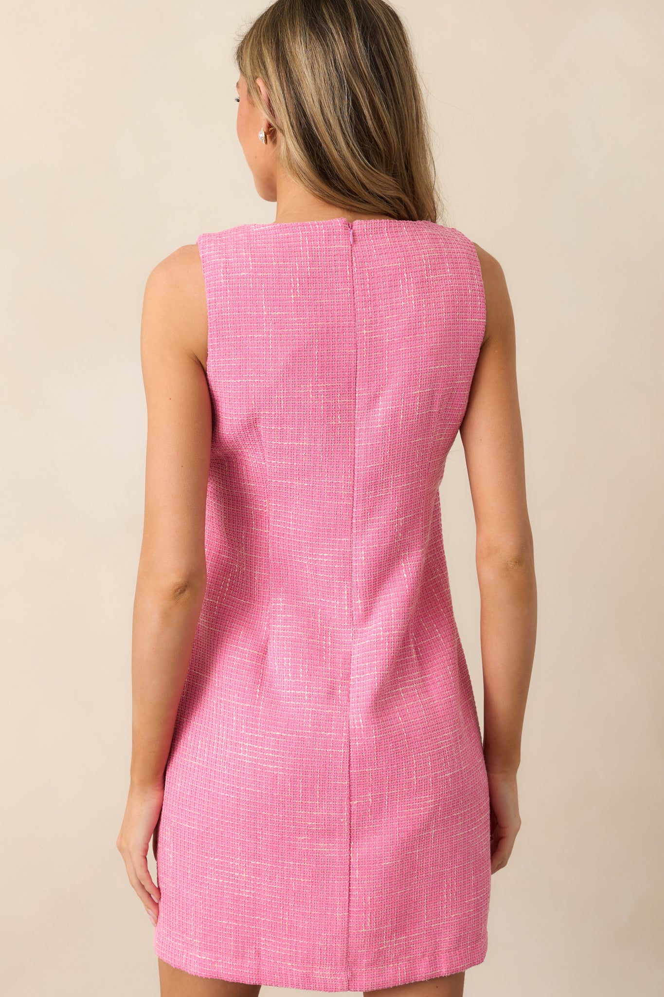 A back view of the dress showcasing the discrete back zipper and the clean, seamless design of the mini-length hemline.