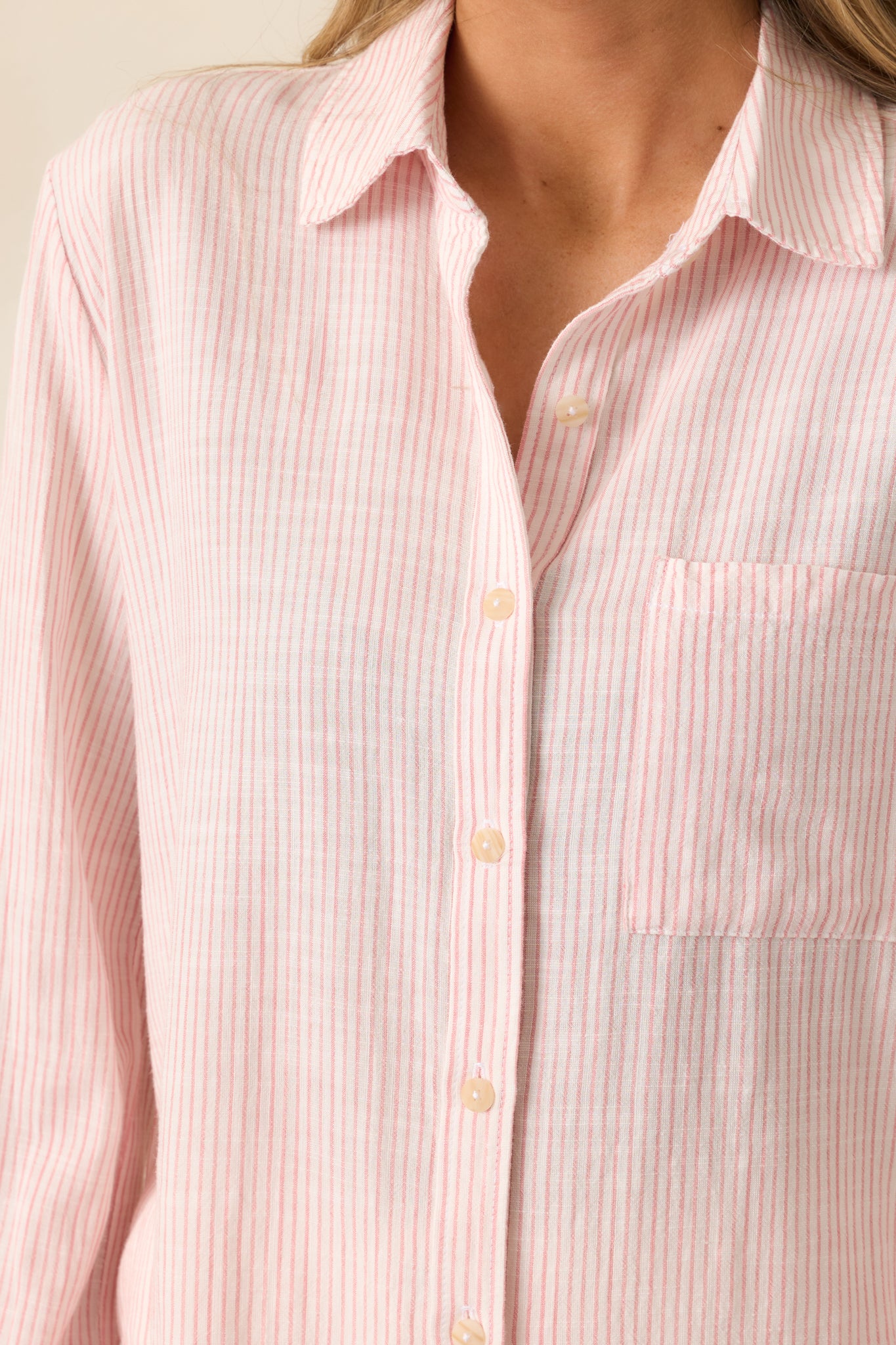 A detailed view of the striped print on the pink top, showing the subtle color contrast and fabric texture.