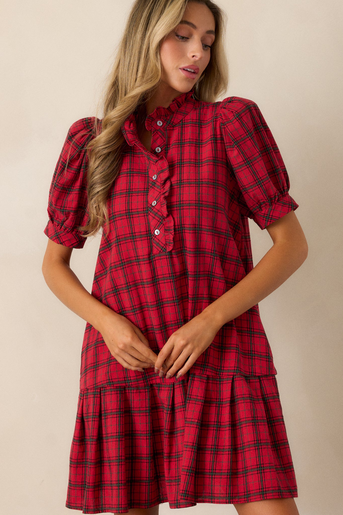 Close-up of the puff sleeves and shoulder area, capturing the plaid design and ruffled collar detail.