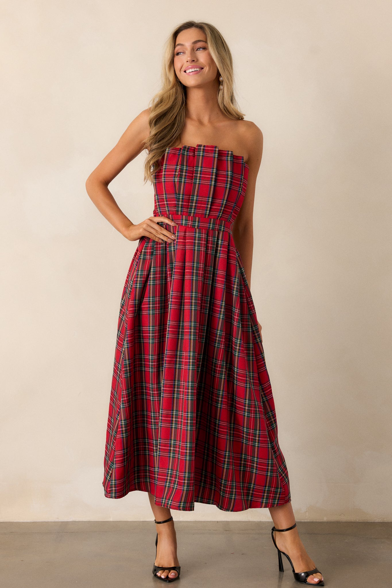 A front view capturing the entire dress, focusing on the vibrant plaid pattern and the flattering pleats that accentuate the waist.