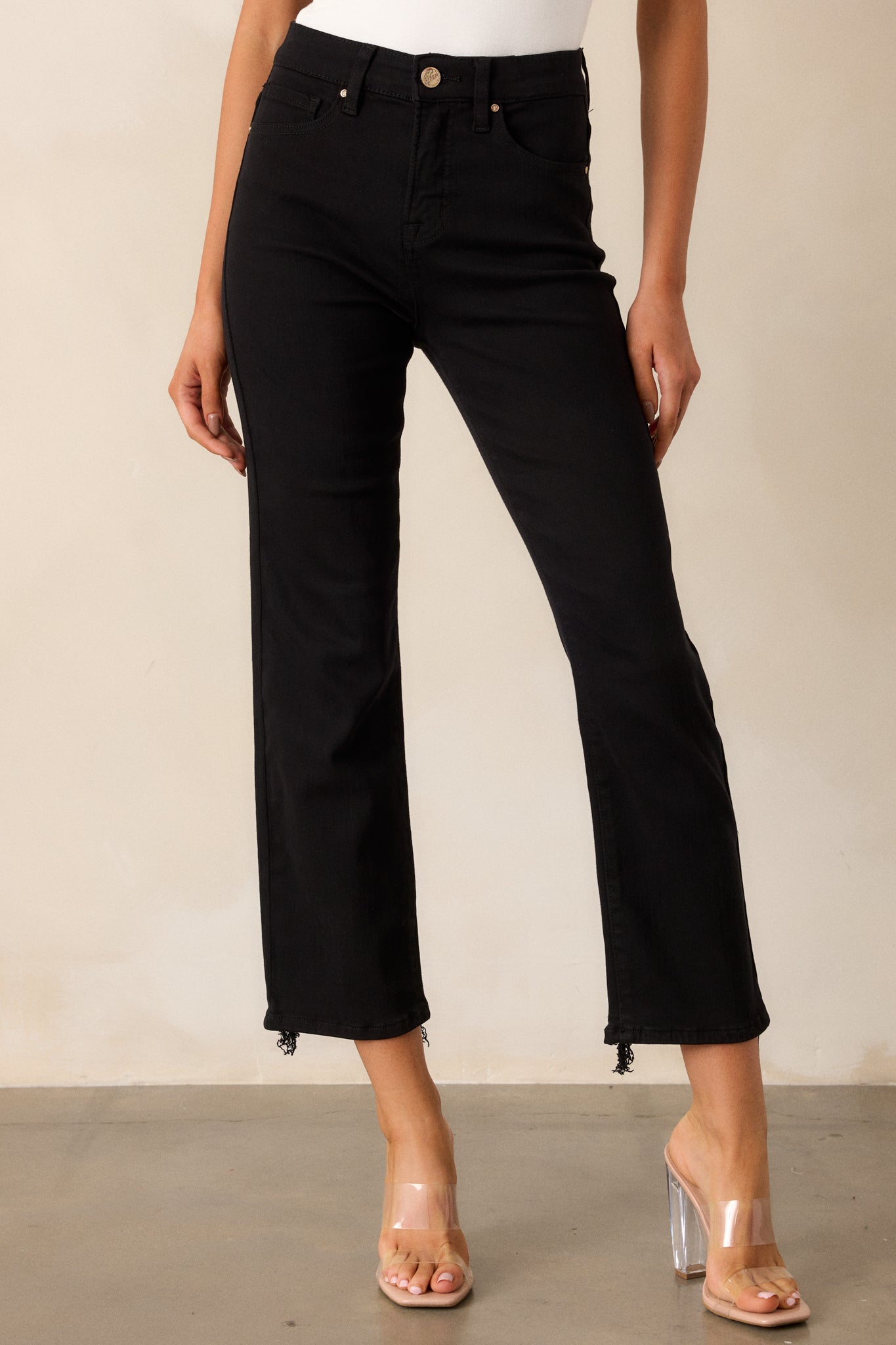 Front view of the black jeans, emphasizing the straight leg design and the sleek appearance of the fabric.