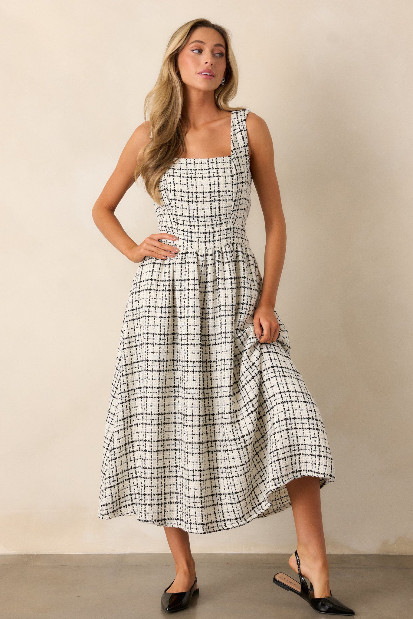 Full-length shot highlighting the tweed pattern of the dress and the seamless transition from the fitted bodice to the flared skirt.
