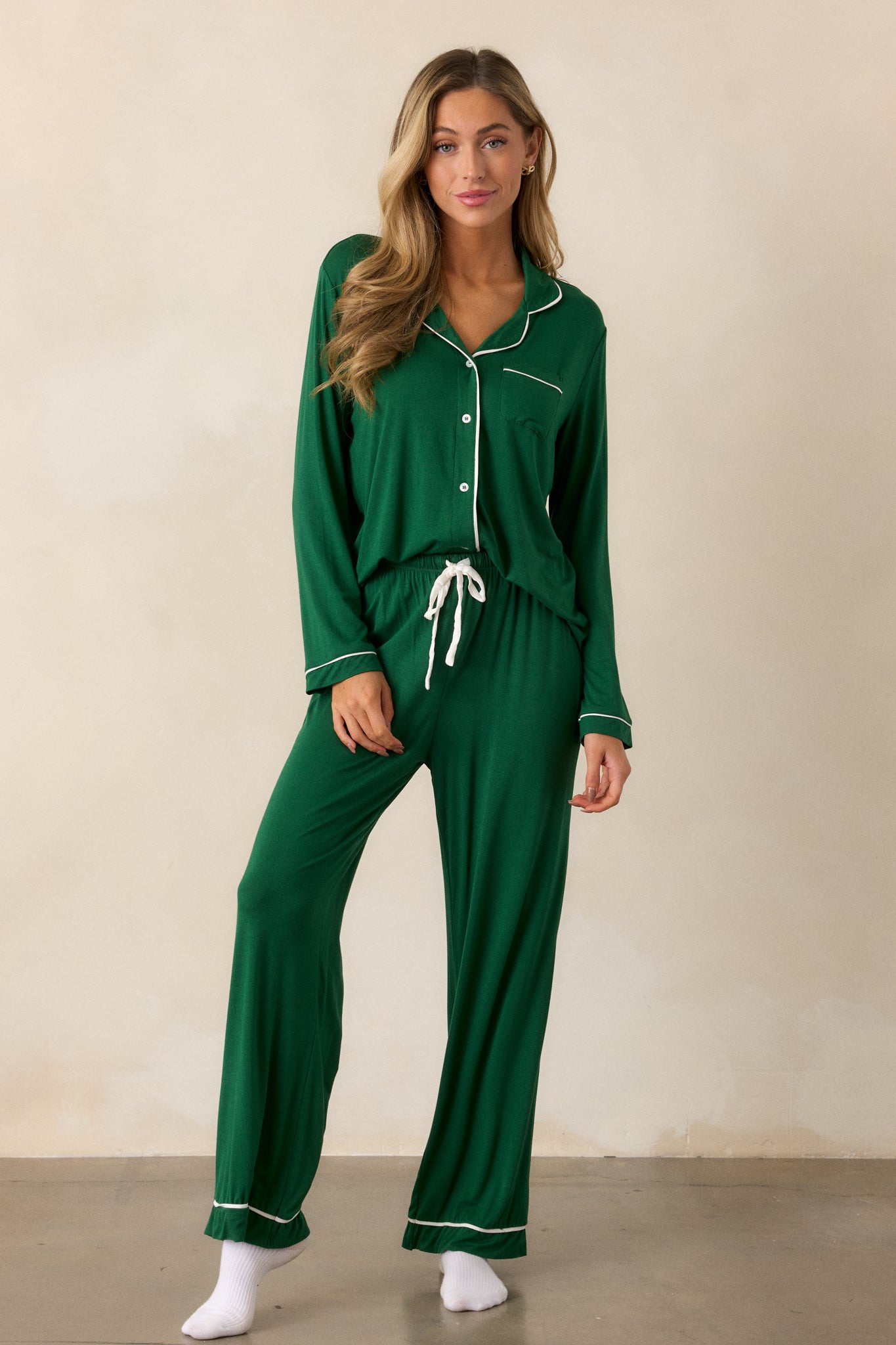 These forest green Pajama Pants feature an elastic drawstring waistband with a white string, white trim detailing and long relaxed pant legs.