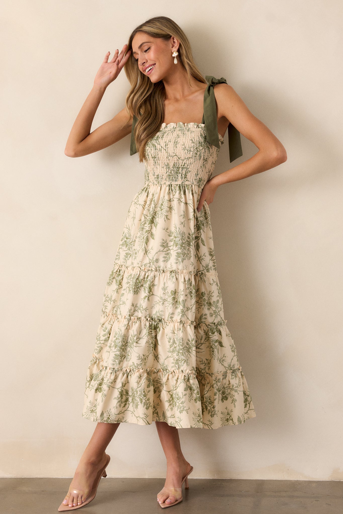 A full-body front angle of the ivory dress, drawing attention to the floral pattern and the gentle drape of the midi-length fabric.