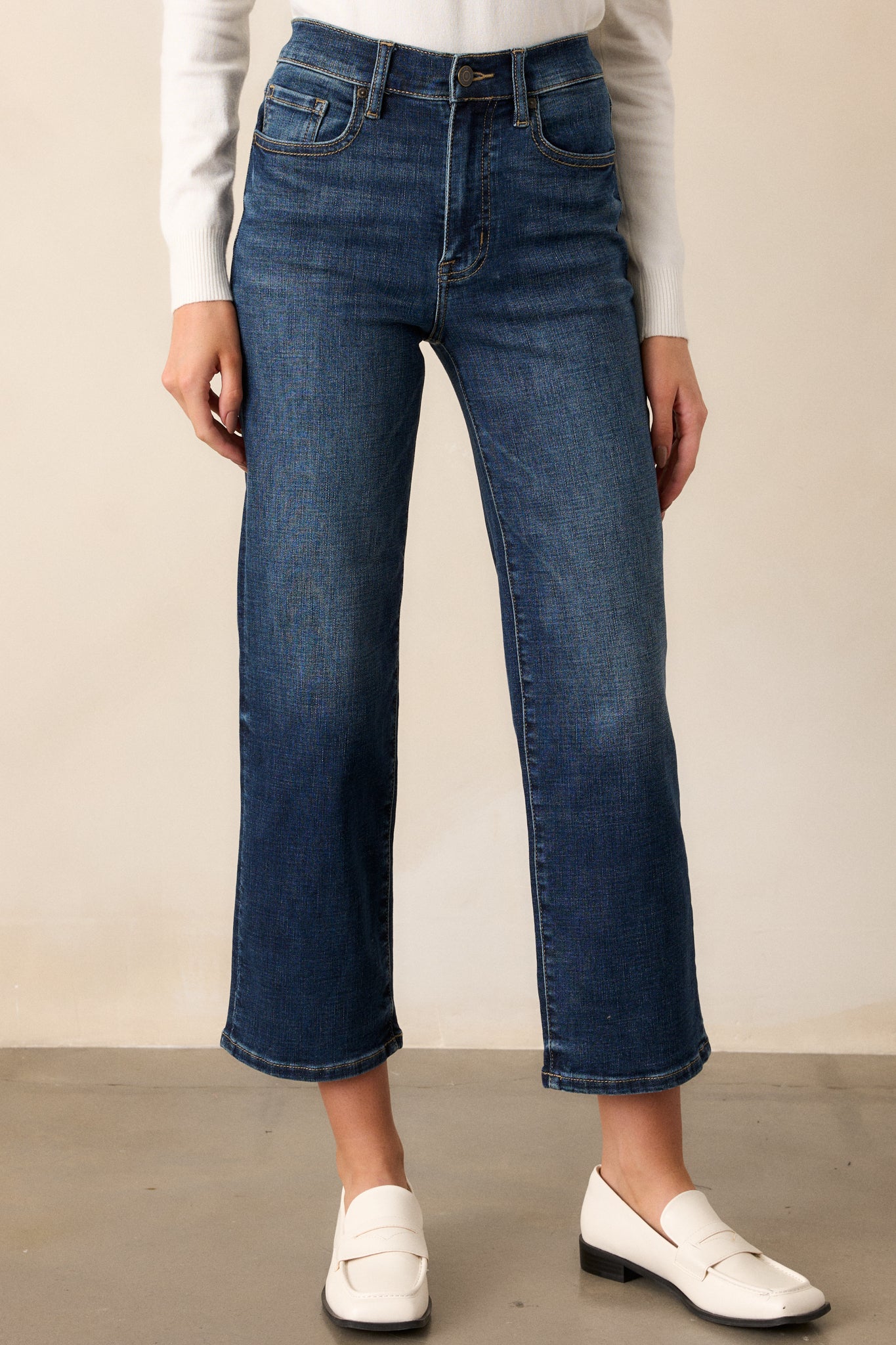 Focused view of the lower half of the jeans, highlighting the straight leg and dark denim texture near the hem.