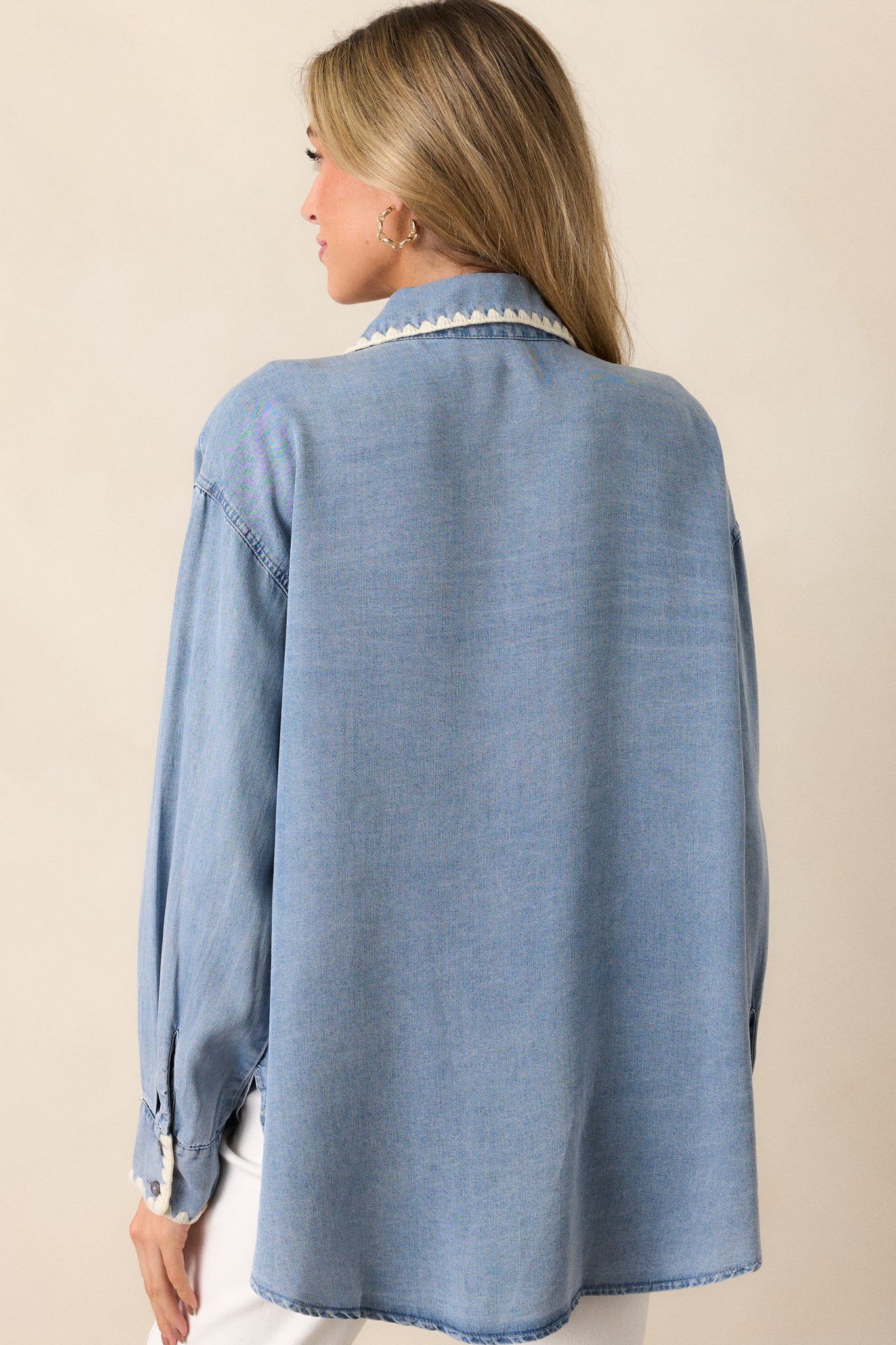 Rear view of the light wash chambray top, focusing on the smooth back panel and light wash fabric with no visible stitching details.