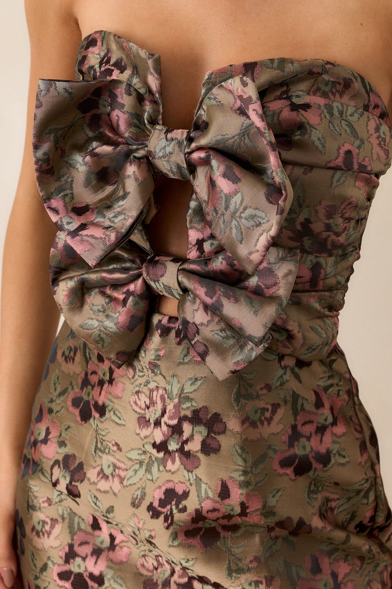 Close-up of the jacquard fabric pattern on the sage green dress, showcasing the texture and elegance of the material.