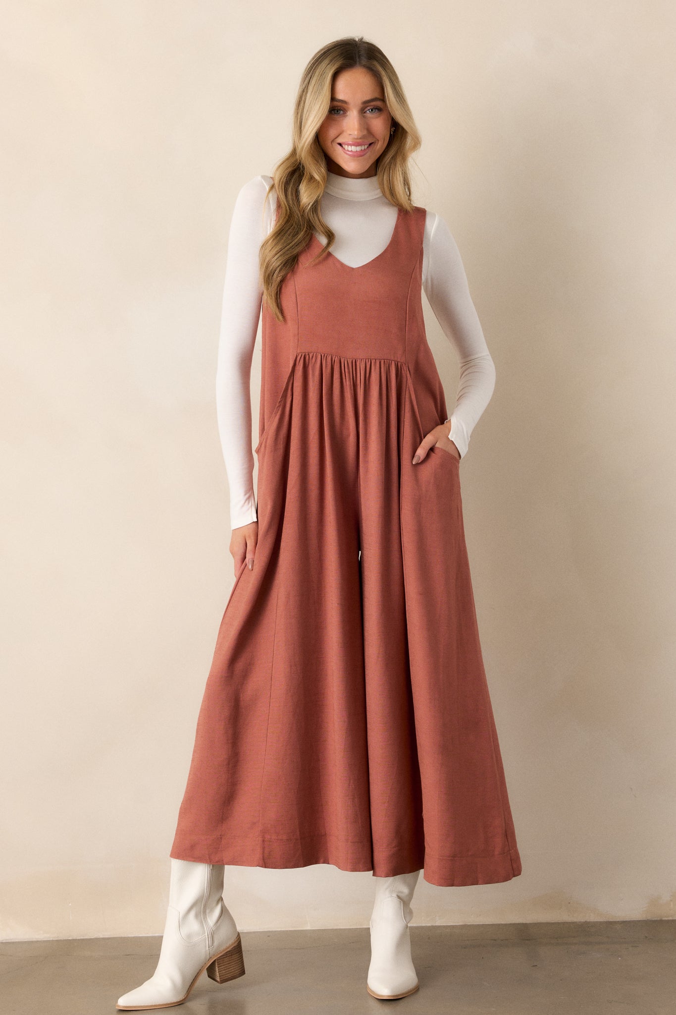 A full-body shot from the side, capturing the movement of the flowy wide legs and the flattering silhouette created by the v-neckline.