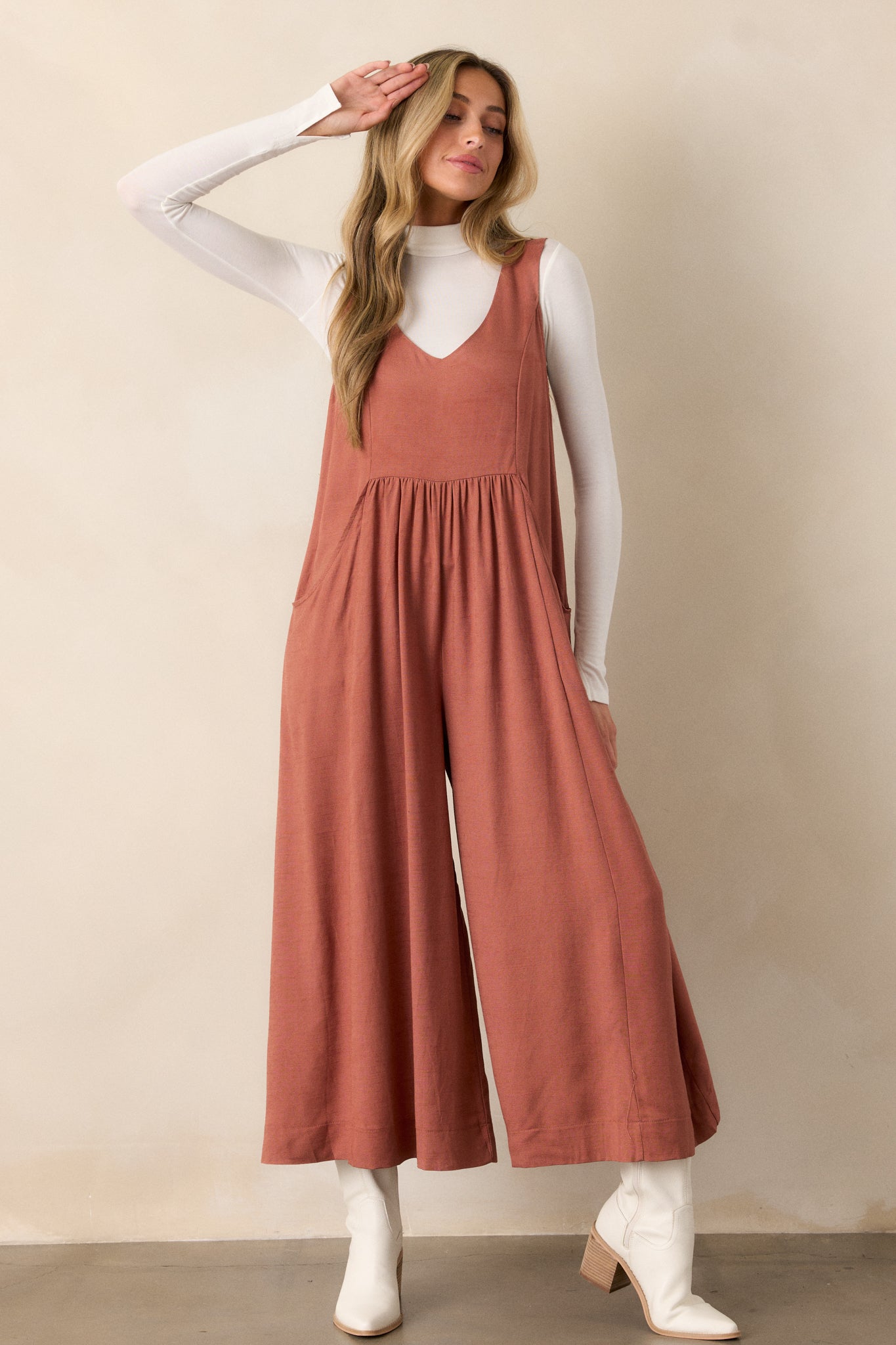 The jumpsuit shown from a frontal perspective, capturing the full length and flow of the wide legs, while also highlighting the functionality of the pockets.