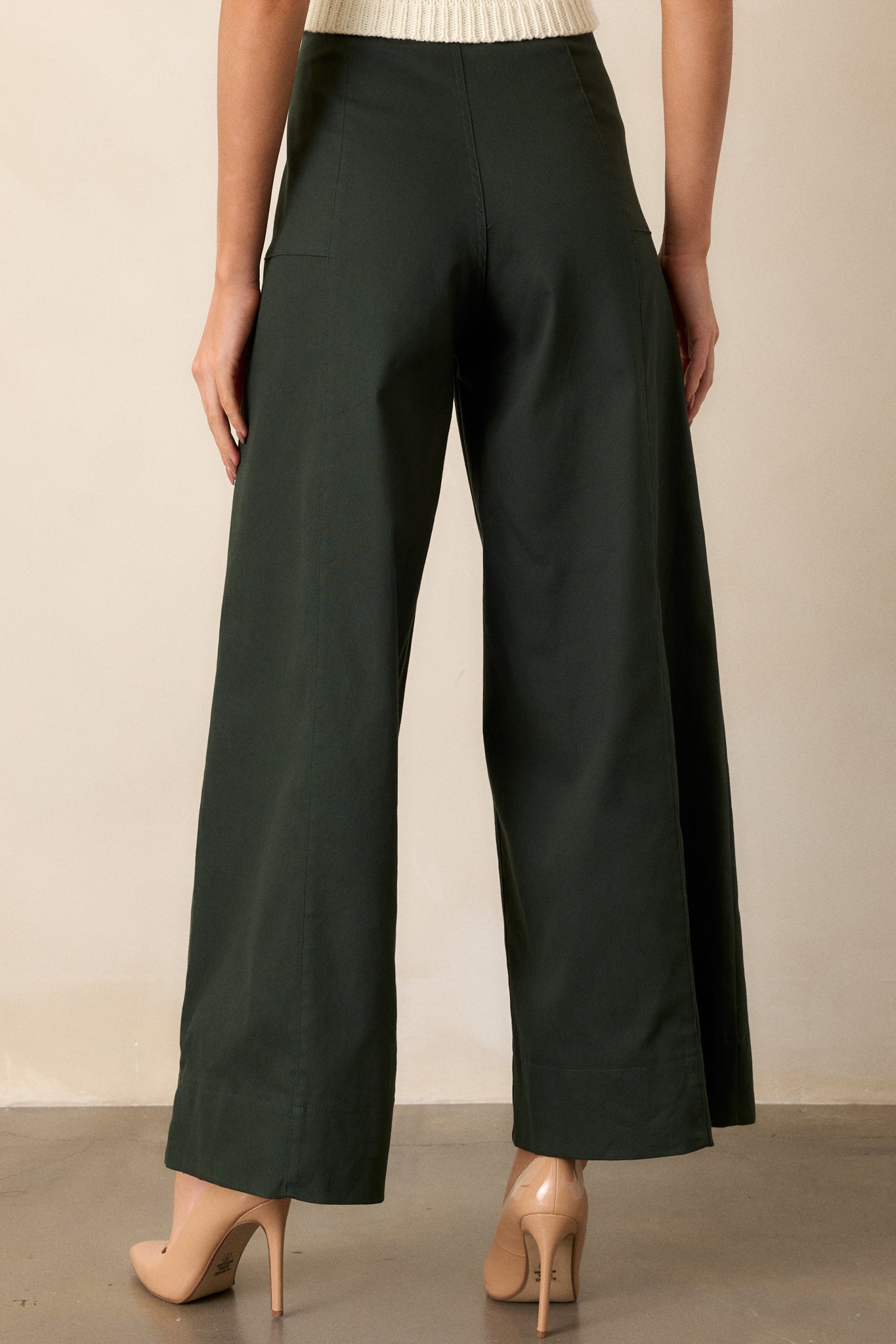 A back view of the forest green pants, showing the seamless design and how the wide leg flows down, providing insight into the overall construction.