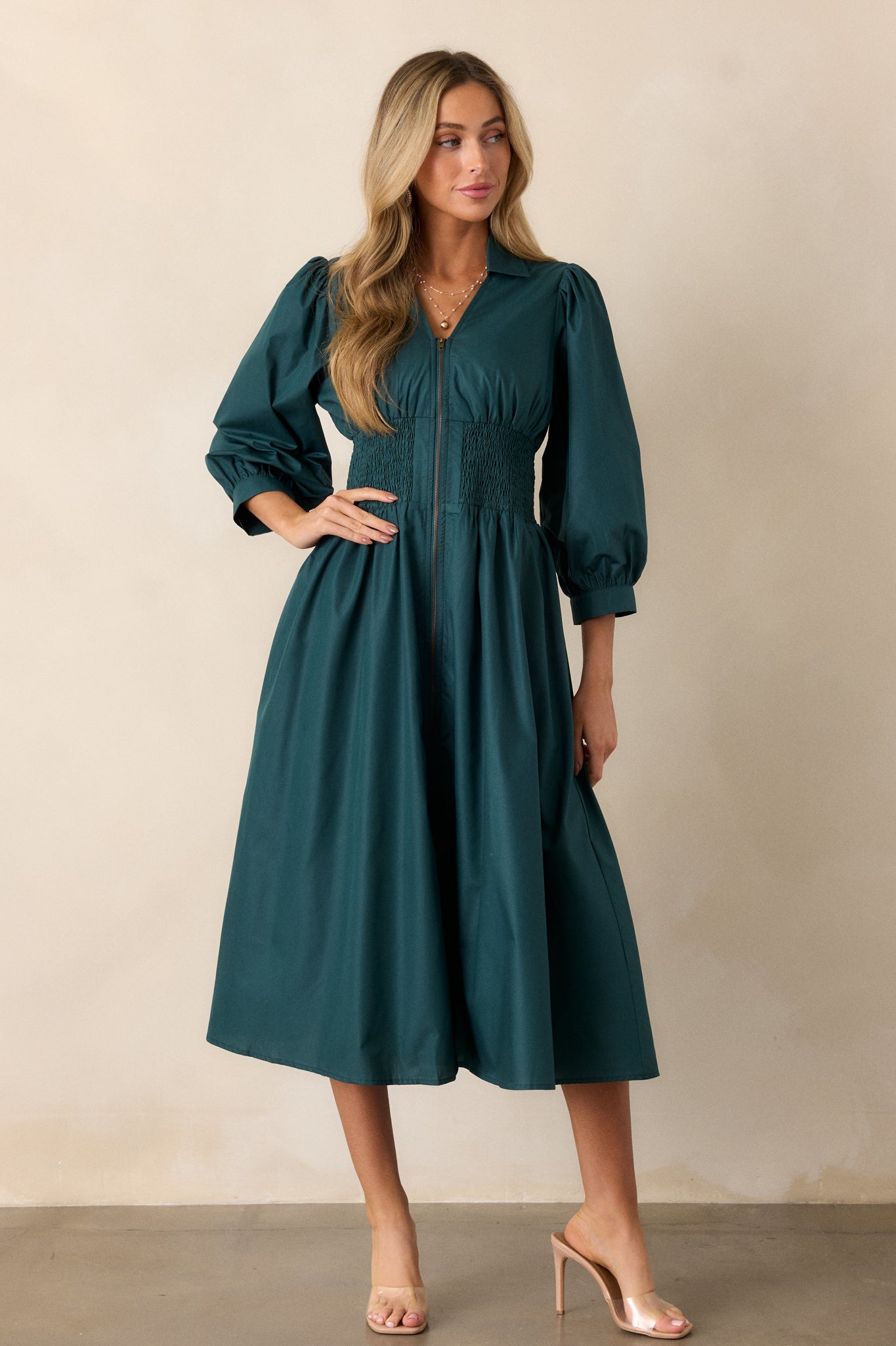 Full-length shot of the dress, highlighting the smocked waist detailing and the flow of the midi-length skirt.