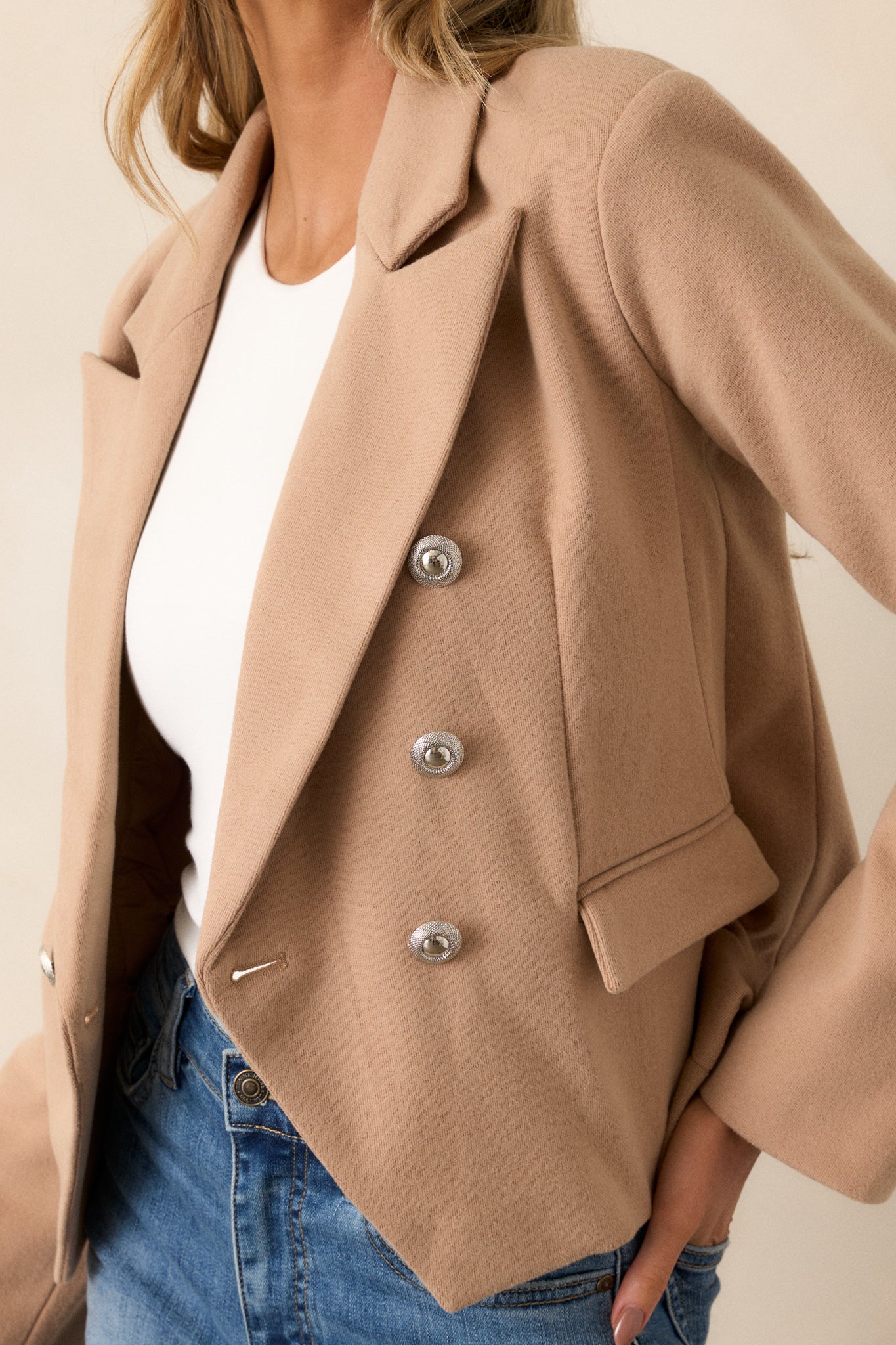 A close-up of the front pockets, highlighting their placement and functionality within the cropped design.