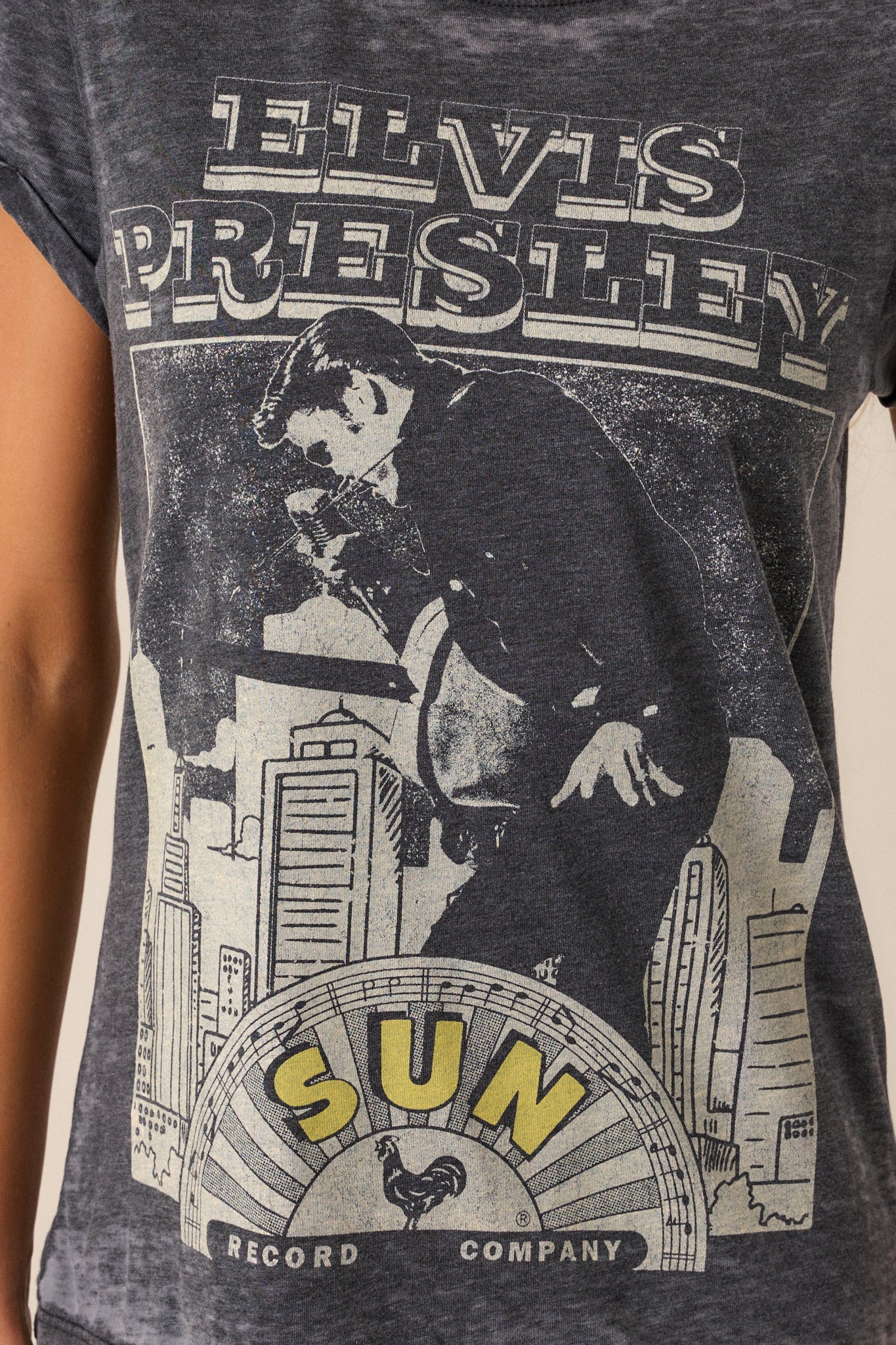 Detailed close-up of the fabric’s acid wash pattern, with emphasis on the worn, textured look around the Elvis Presley design.