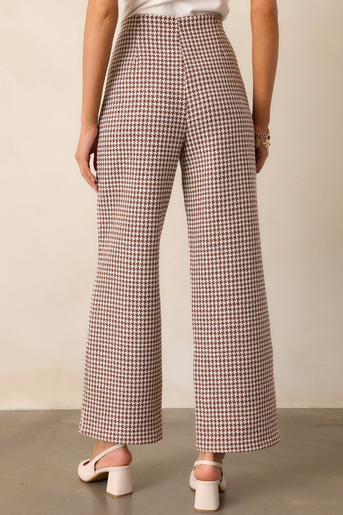 Back view of the pants, showing the high waist, straight leg cut, and the houndstooth print pattern from the rear.