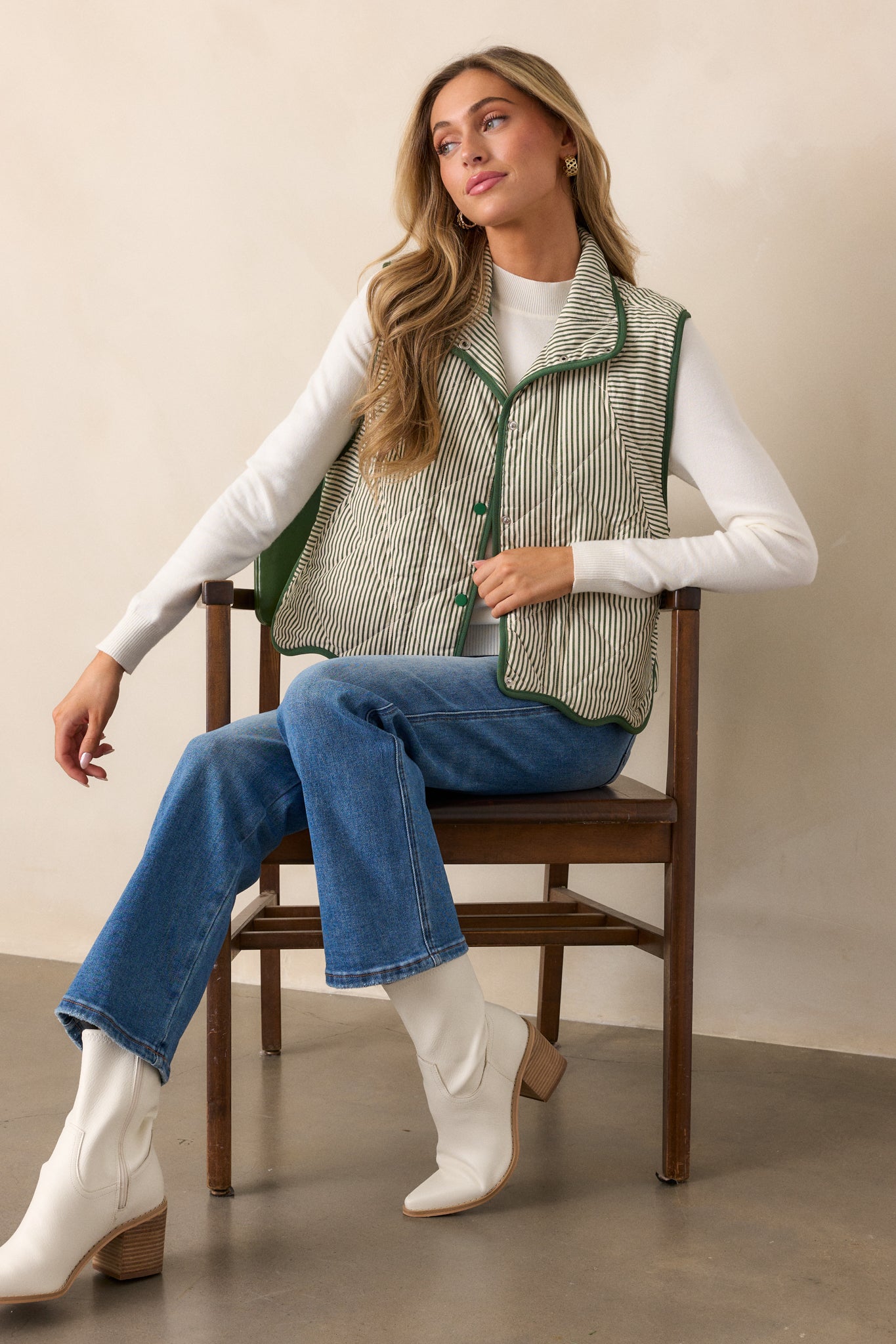 Close-up of the vest’s collared neckline and snap-button front, showcasing the quilted stripe detailing across the chest.