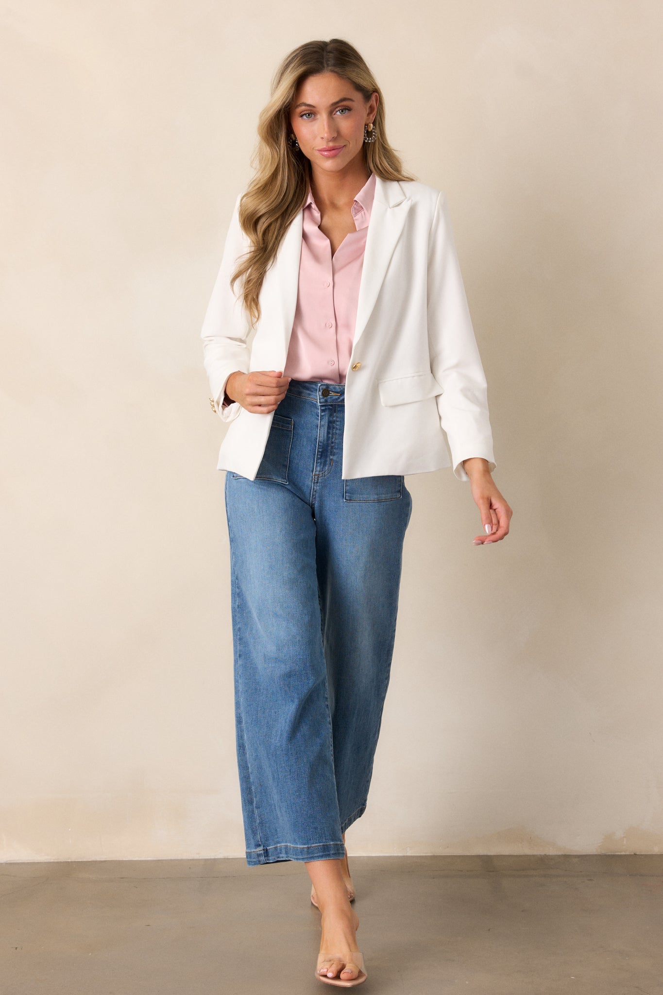 A full-length view of the white blazer, highlighting the gold hardware and sharp v-neck collar for a polished look.