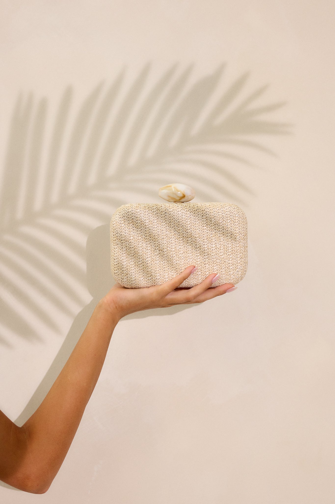 Close-up of a sleek clutch showcasing its smooth texture and elegant design, with visible stitching and a stylish closure.