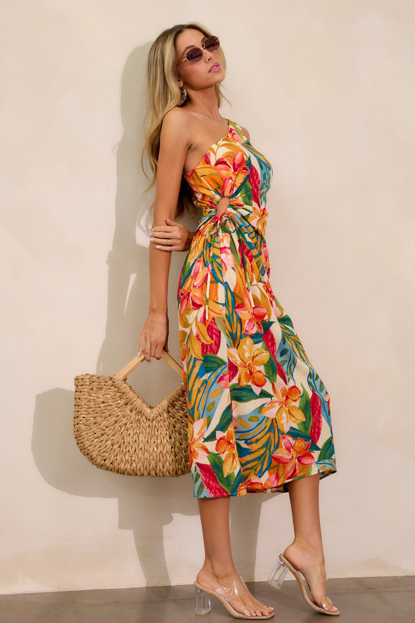 Full-length view of the multi-print dress, featuring a flowing silhouette, asymmetric neckline, and the one-shoulder design, with the self-tie side cut-out detail adding texture.