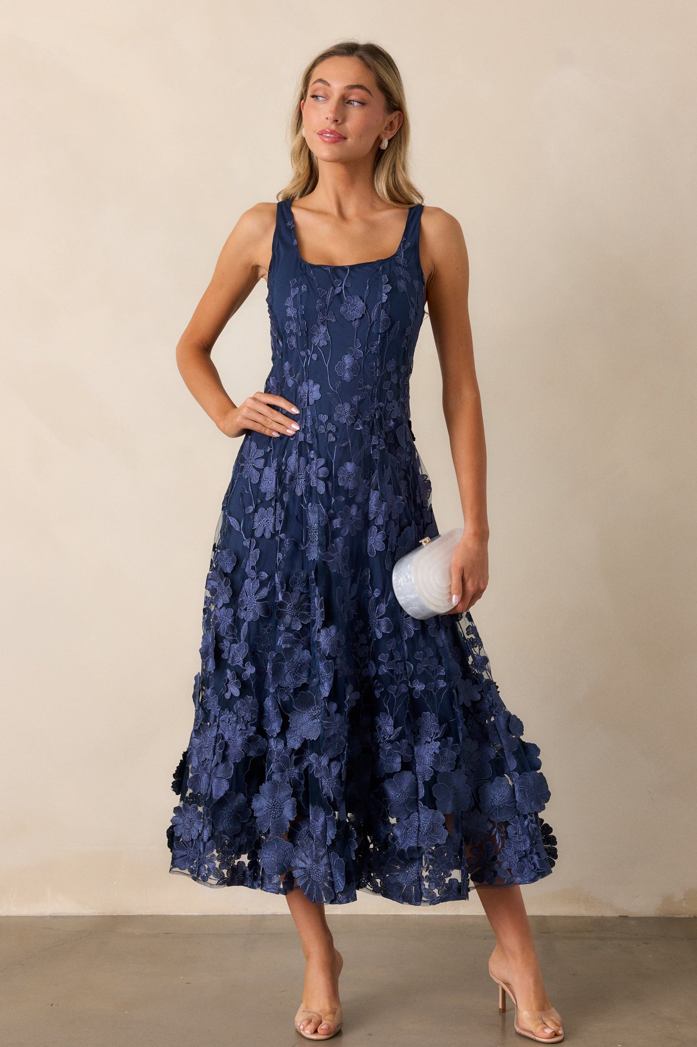 Full-body view of the dress, highlighting the sleeveless design and square neckline in detail.