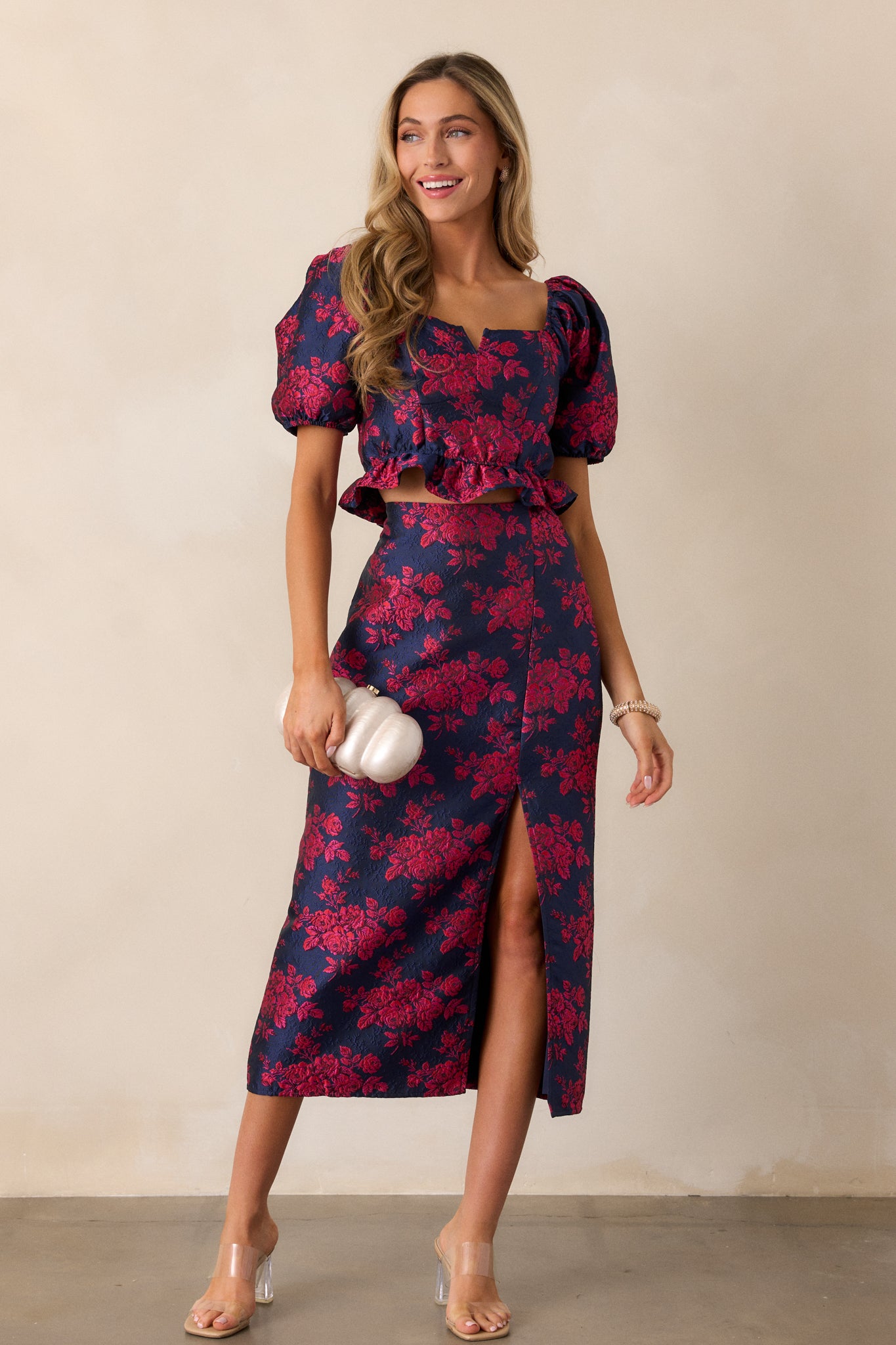 Full length view of the magenta top, emphasizing the balanced v-neck neckline and the flowy ruffle detail at the bottom.