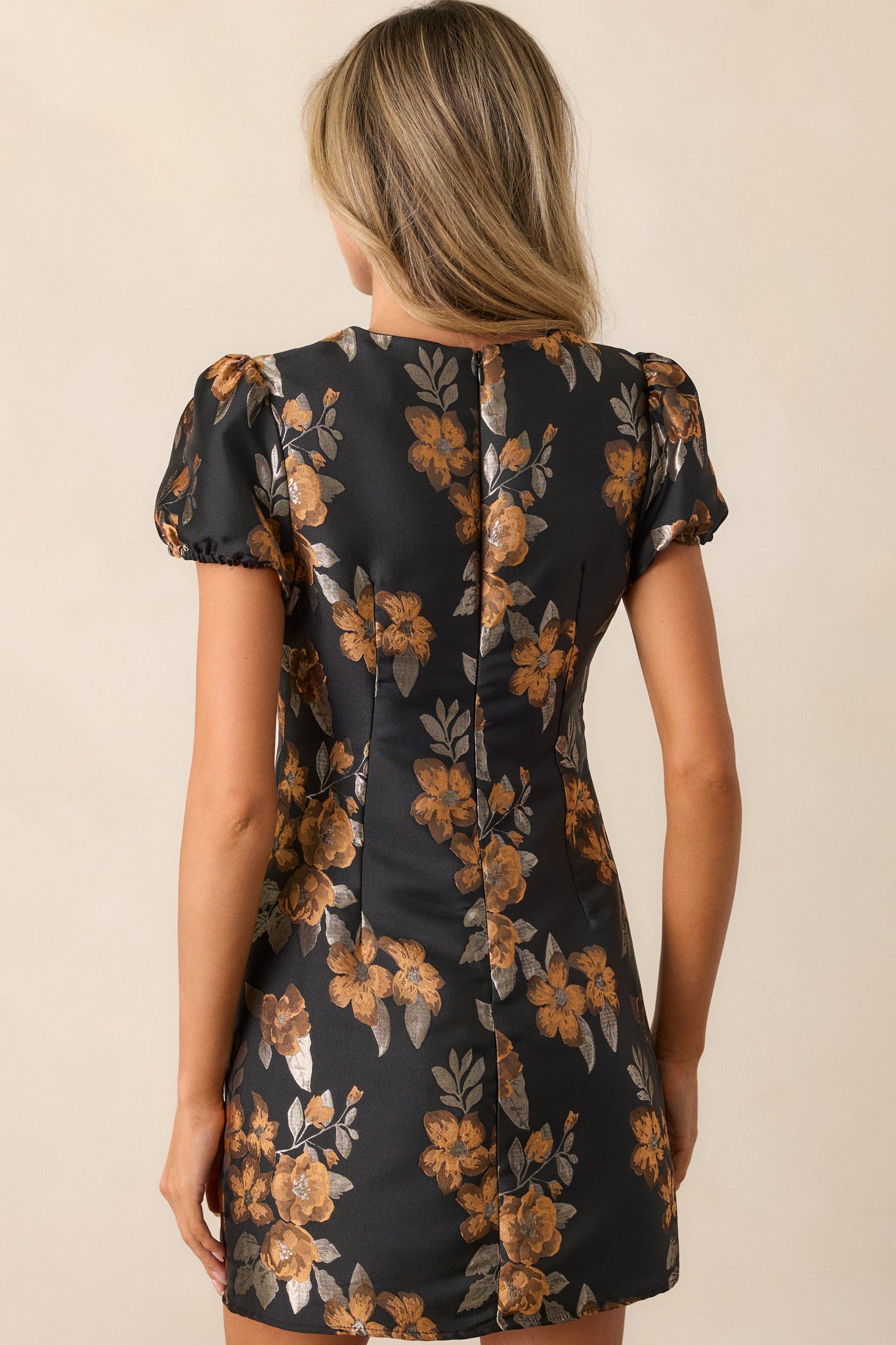 A back view of the mini dress, showing the discrete zipper and the overall floral pattern across the structured fit.