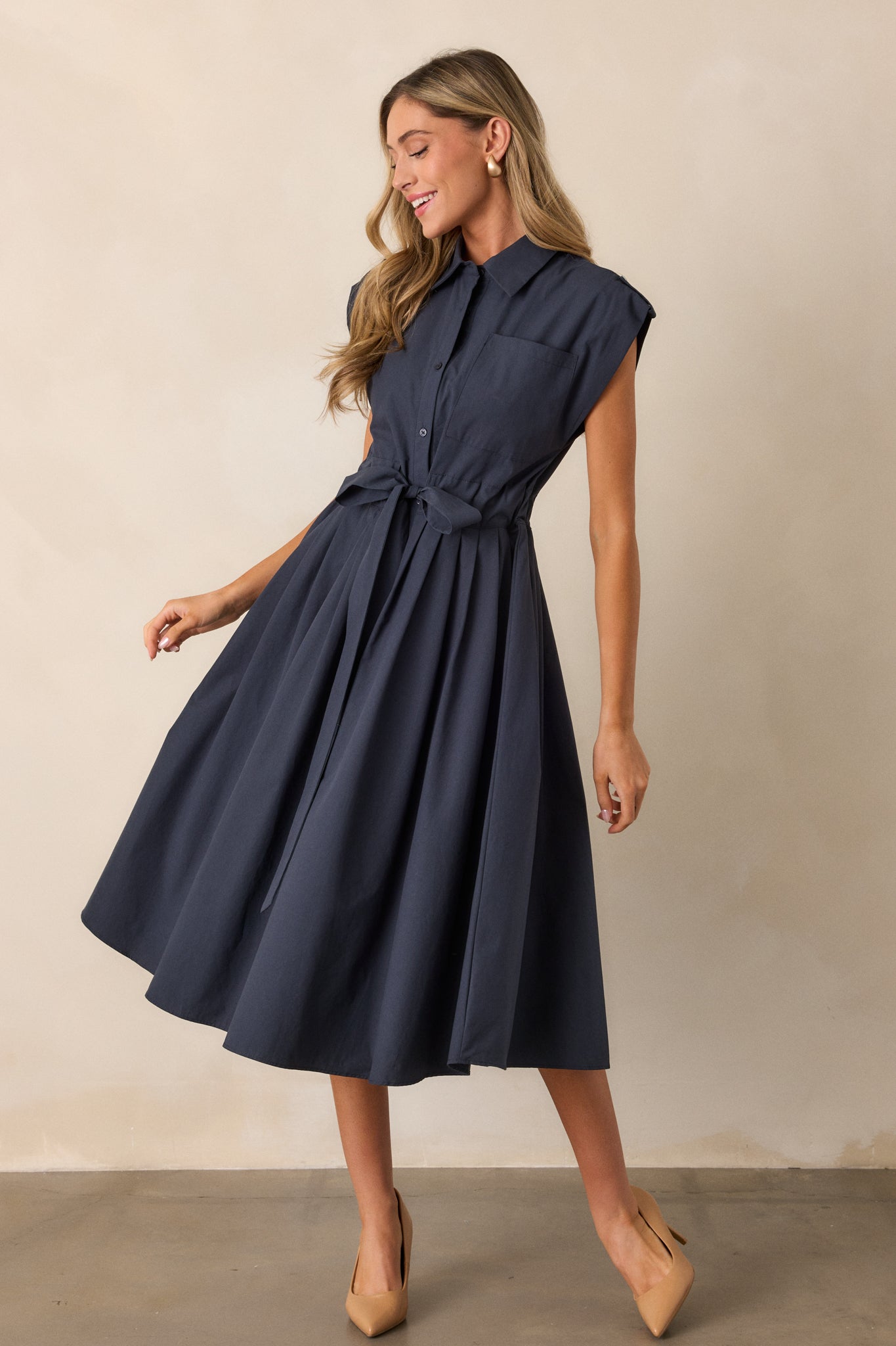 Another full-body shot of the navy dress emphasizing its versatility, with the self-tie belt accentuating the waist and the collared neckline adding a touch of sophistication.