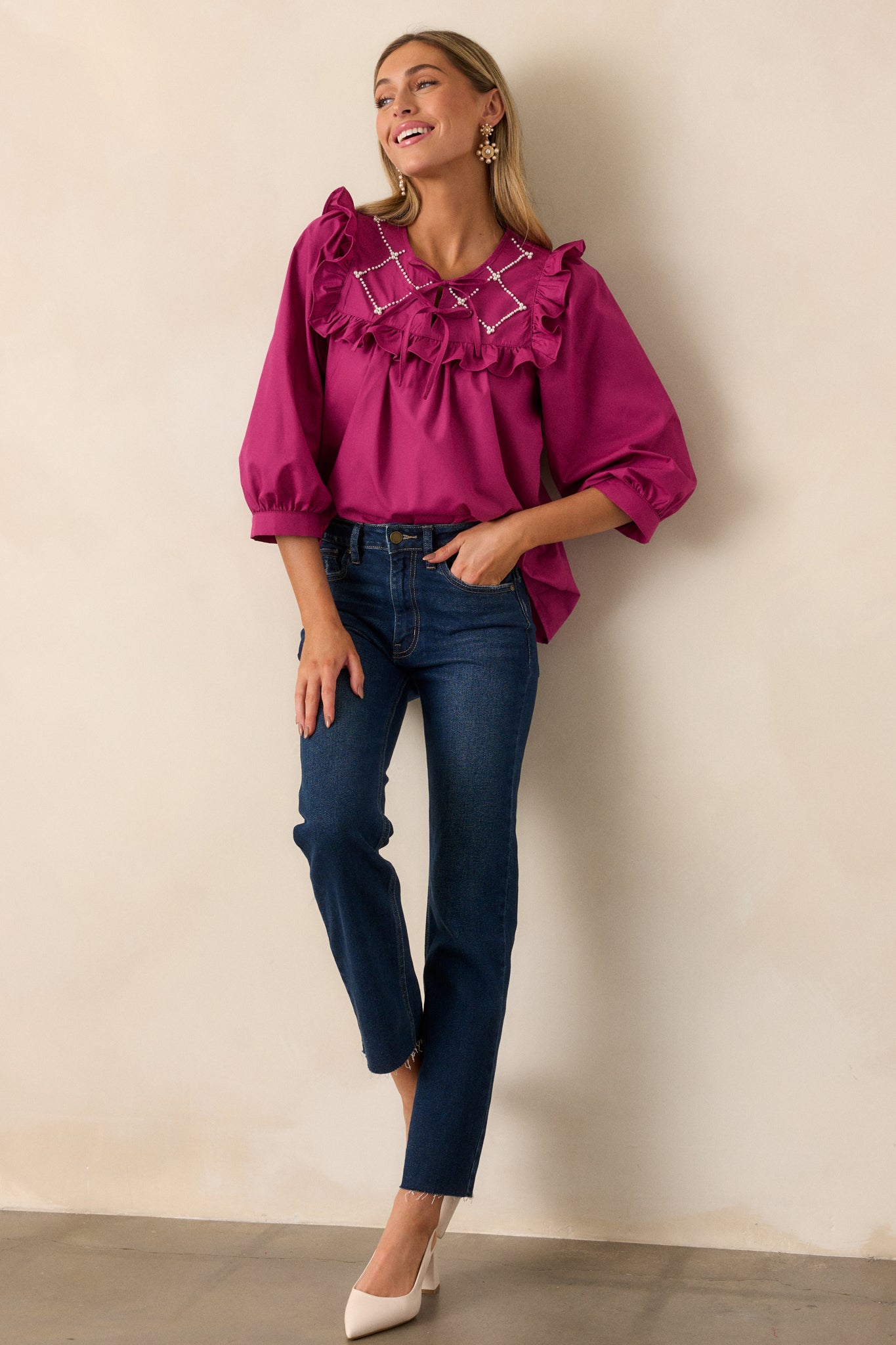 The dark fuchsia top displayed in full view, highlighting the elegant 3/4 length puff sleeves and the overall flattering silhouette.