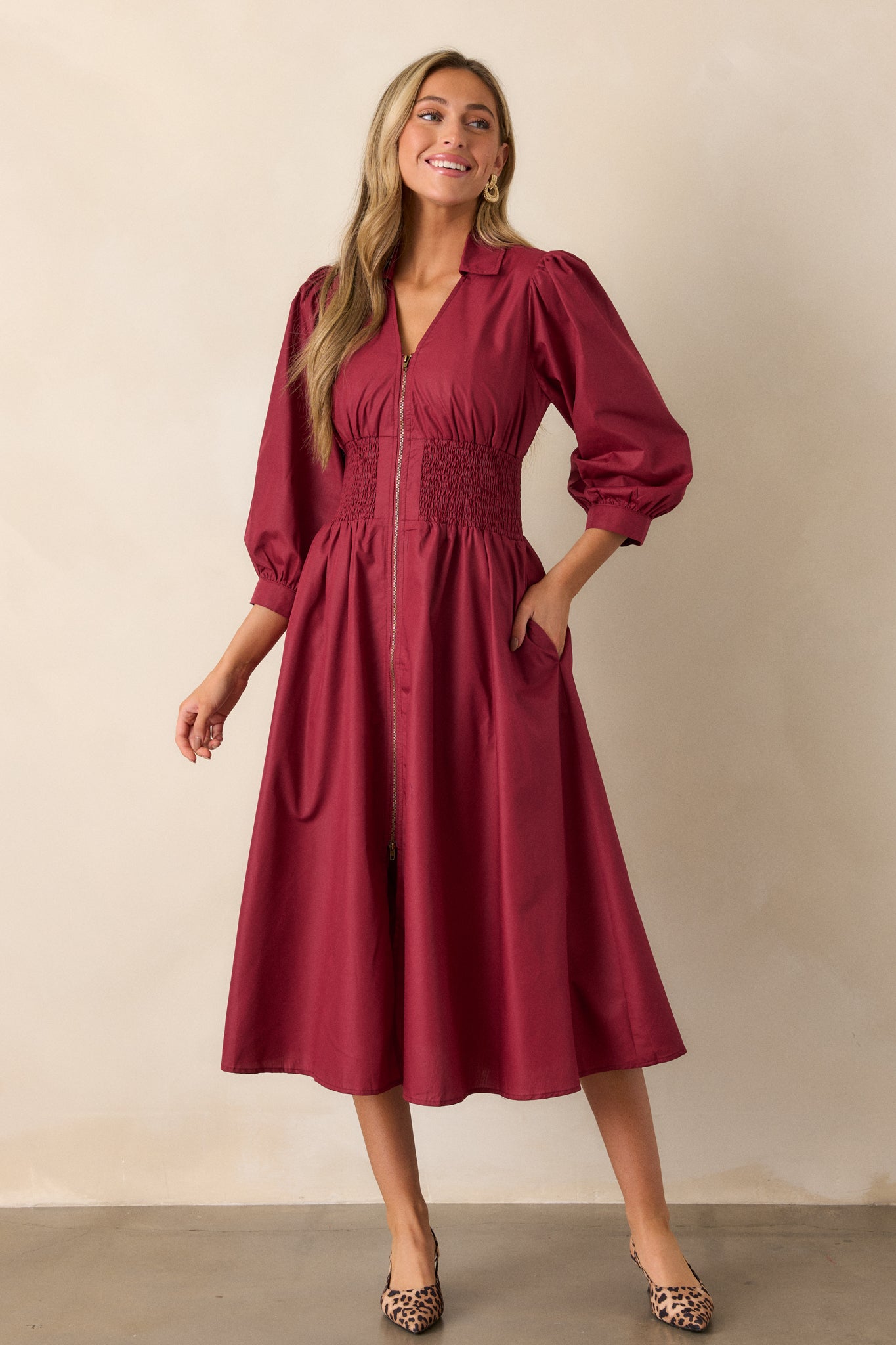 Full-length shot of the dress, highlighting the smocked waist detailing and the flow of the midi-length skirt.