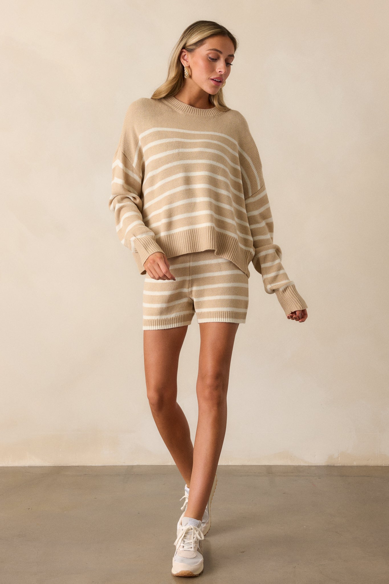 A full view of the taupe and ivory knit shorts, showcasing the striped design and relaxed fit.