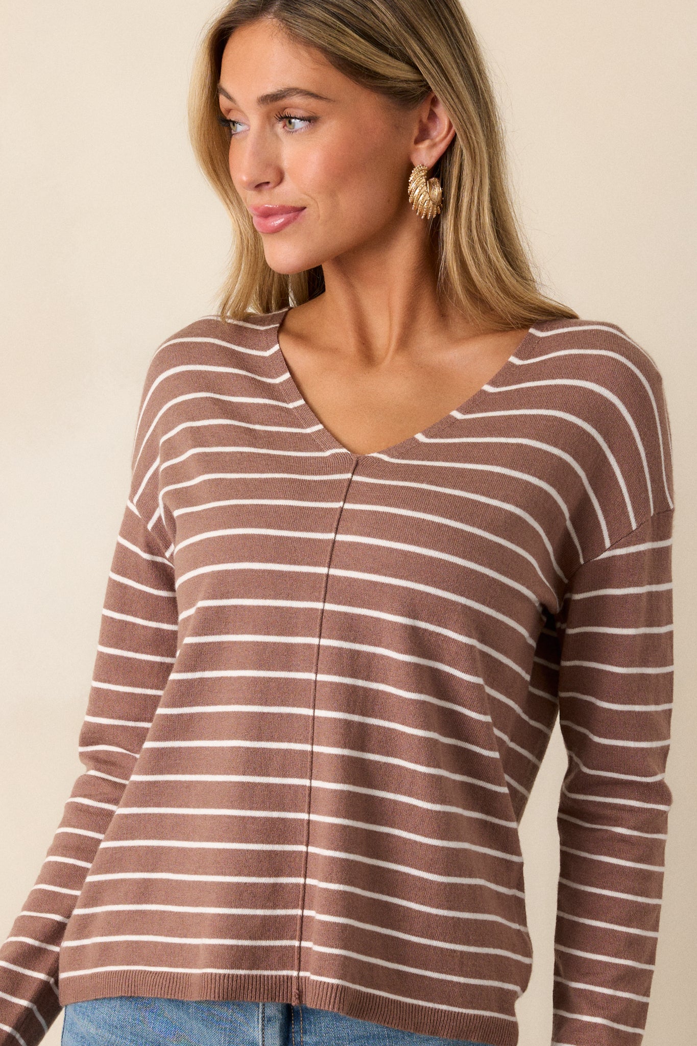 Another front angle of the light mocha top, emphasizing the relaxed fit and v-neckline. The thin white stripes create a clean, sophisticated look with the front seam detailing highlighted down the center.