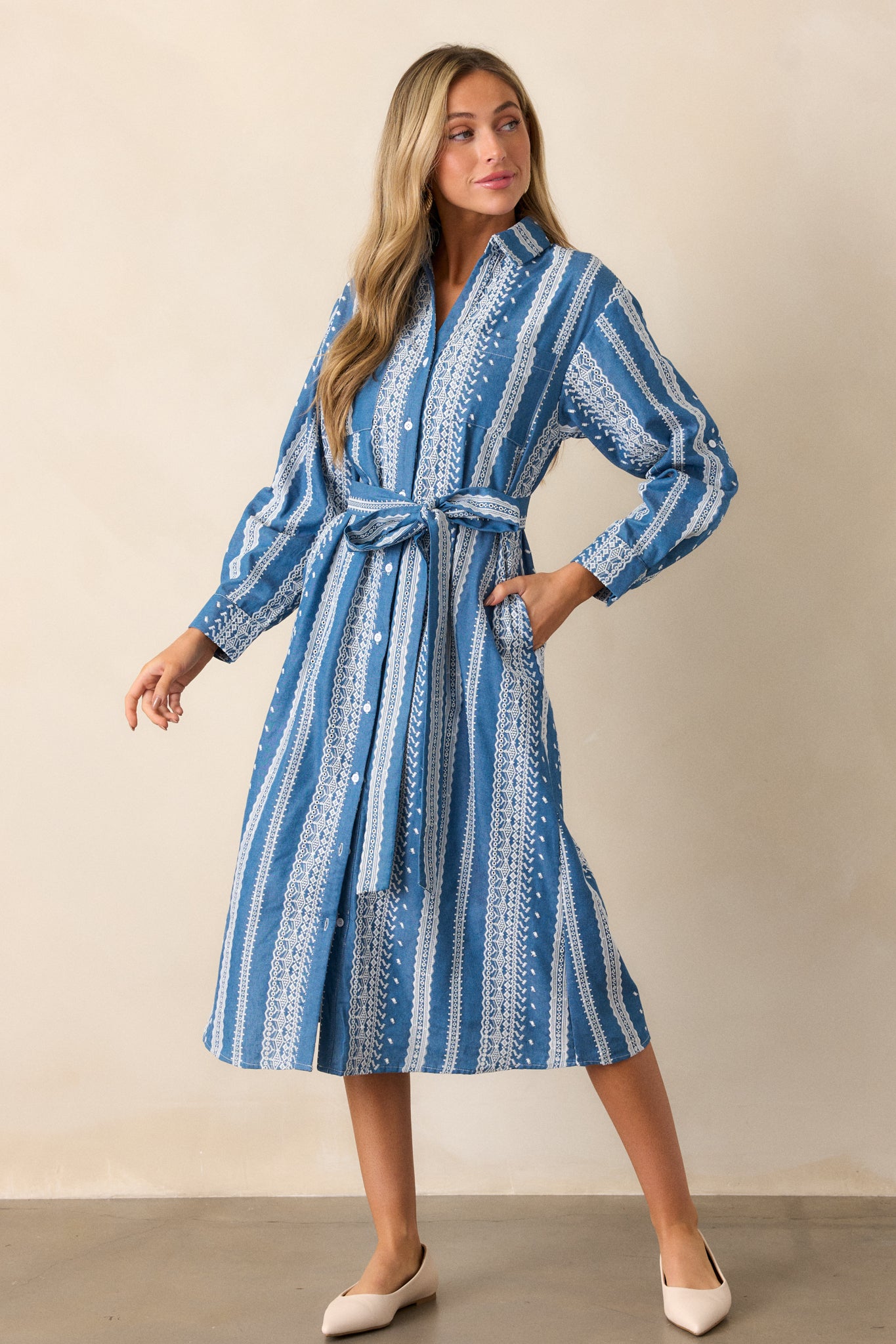 The dress shown from a straight-on angle, emphasizing the long sleeves and the delicate eyelet detailing along the sleeves and hemline.