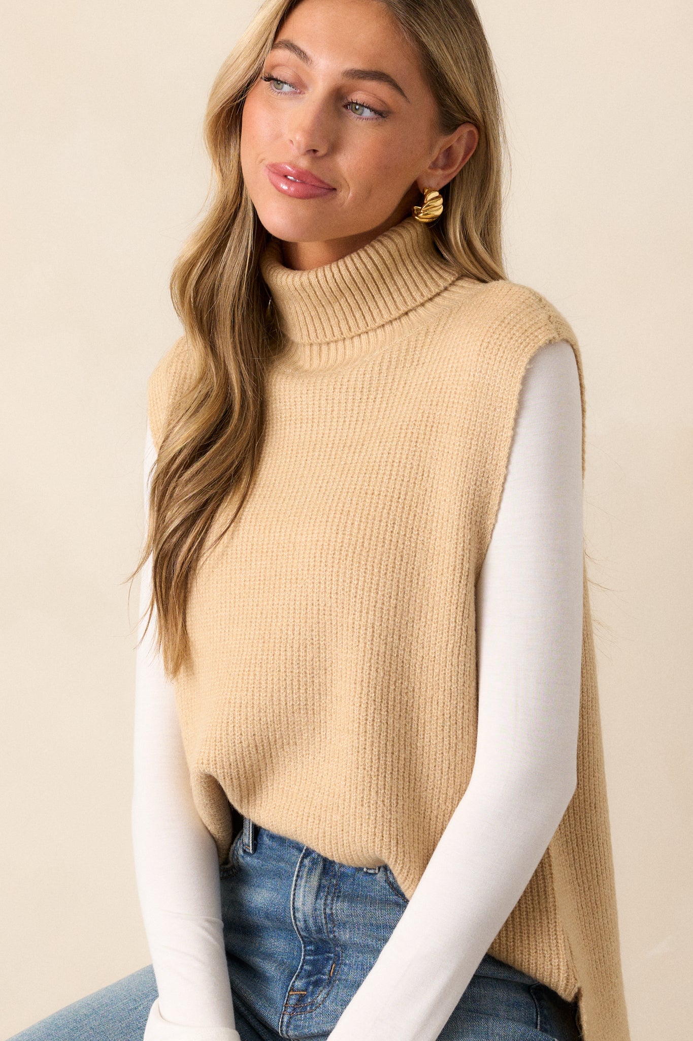 Close-up of the upper section, focusing on the ribbed turtleneck and the soft texture of the sweater material around the neckline and shoulders.