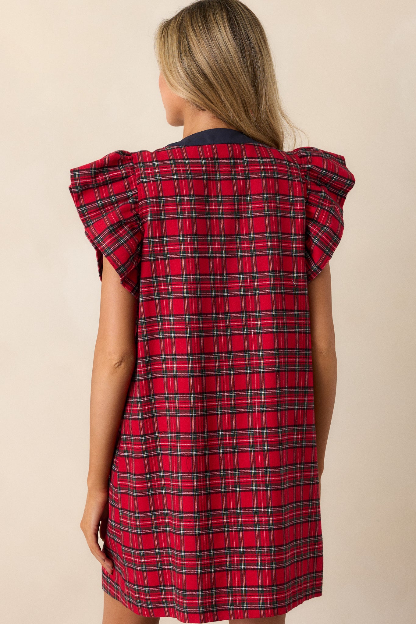 The back of the red and navy plaid mini dress, featuring a relaxed fit and smooth flow with a continuous plaid pattern.