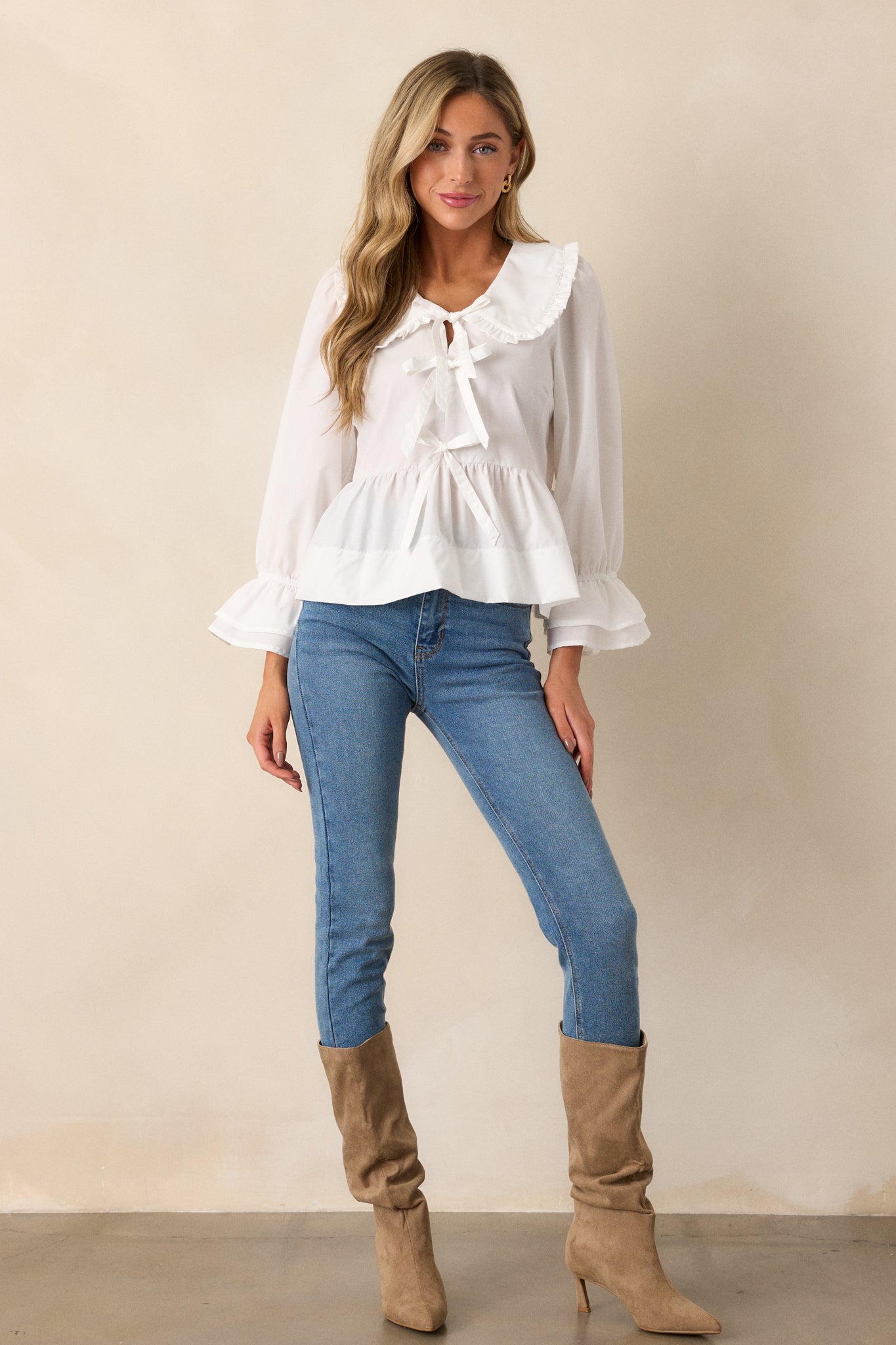 A complete view of the blouse, focusing on the overall silhouette with its flowing, tiered design and soft ruffled detailing.