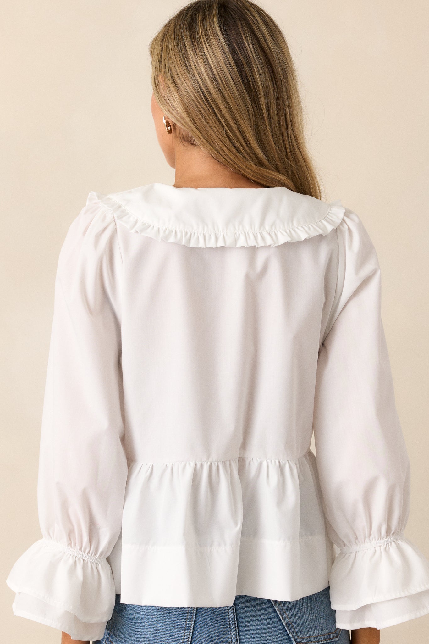 A rear view of the blouse, displaying the tiered, flared fit and how the design extends to the back.