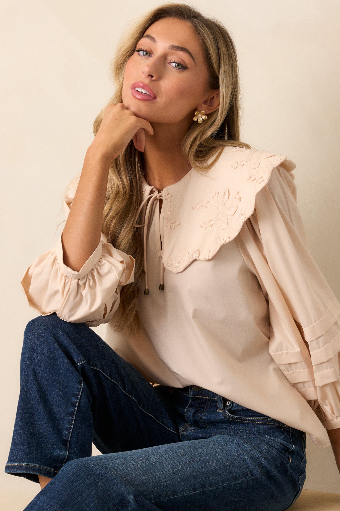 Side view of the blouse, focusing on the flow of the long puff sleeves and the large scalloped collar from a different angle.