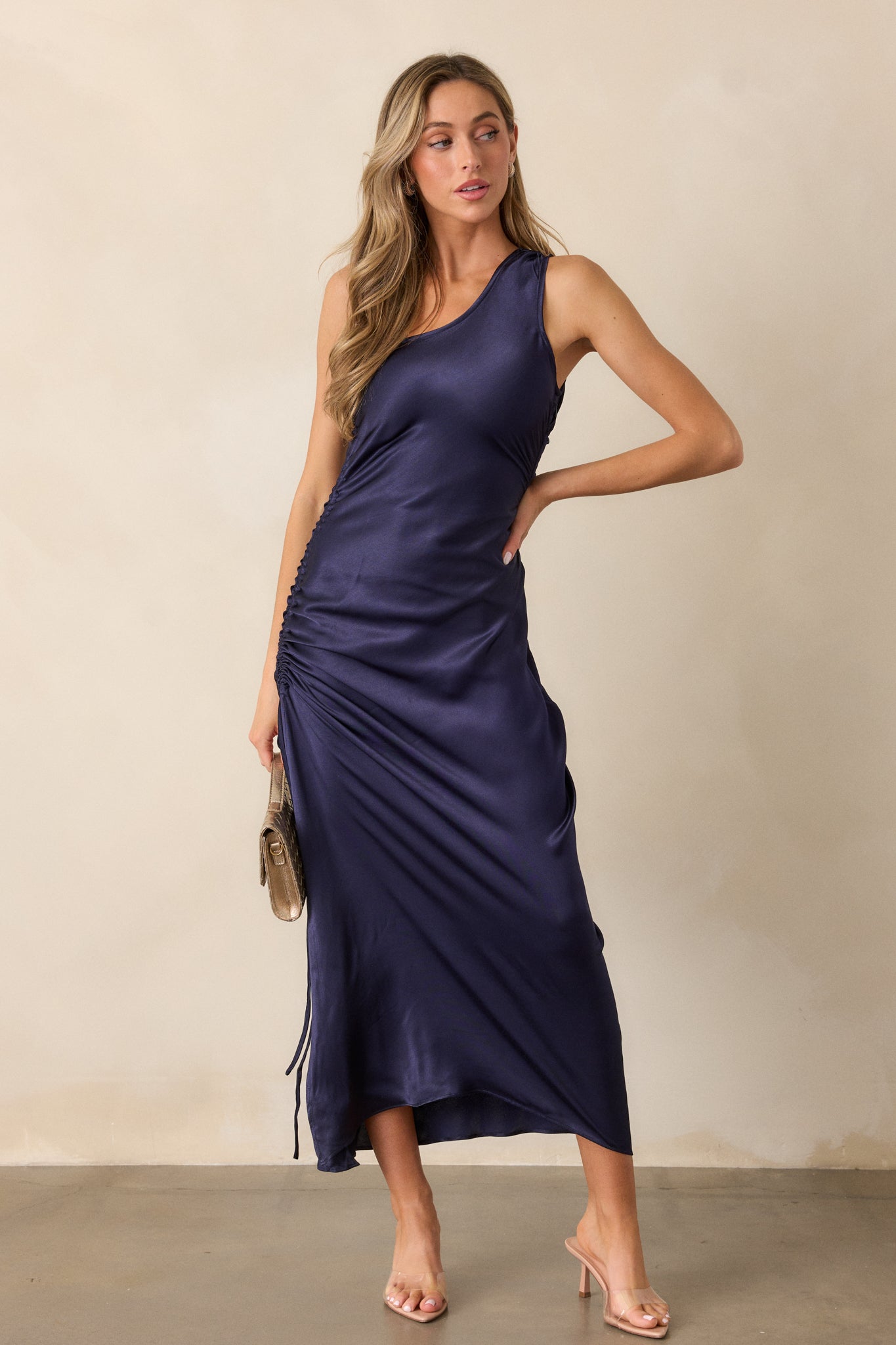 Complete front profile of the dress, focusing on the one-shoulder neckline, the smooth flow of the fitted bodice, and the elegant side slit.