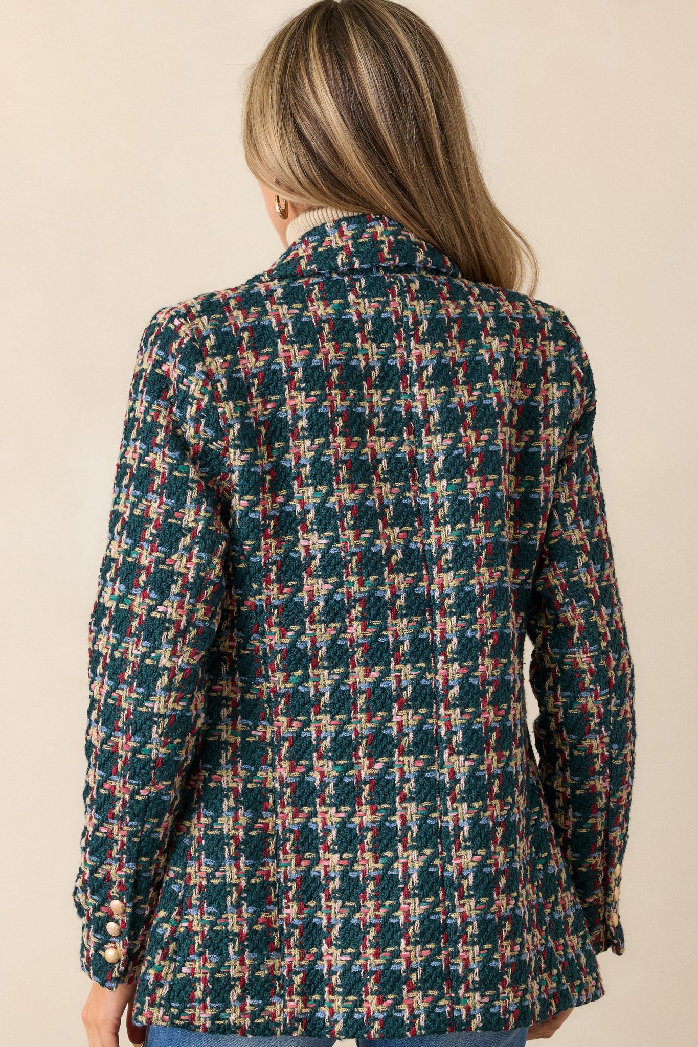 Back view of the coat, focusing on the clean lines, tailored structure, and smooth finish of the green fabric.