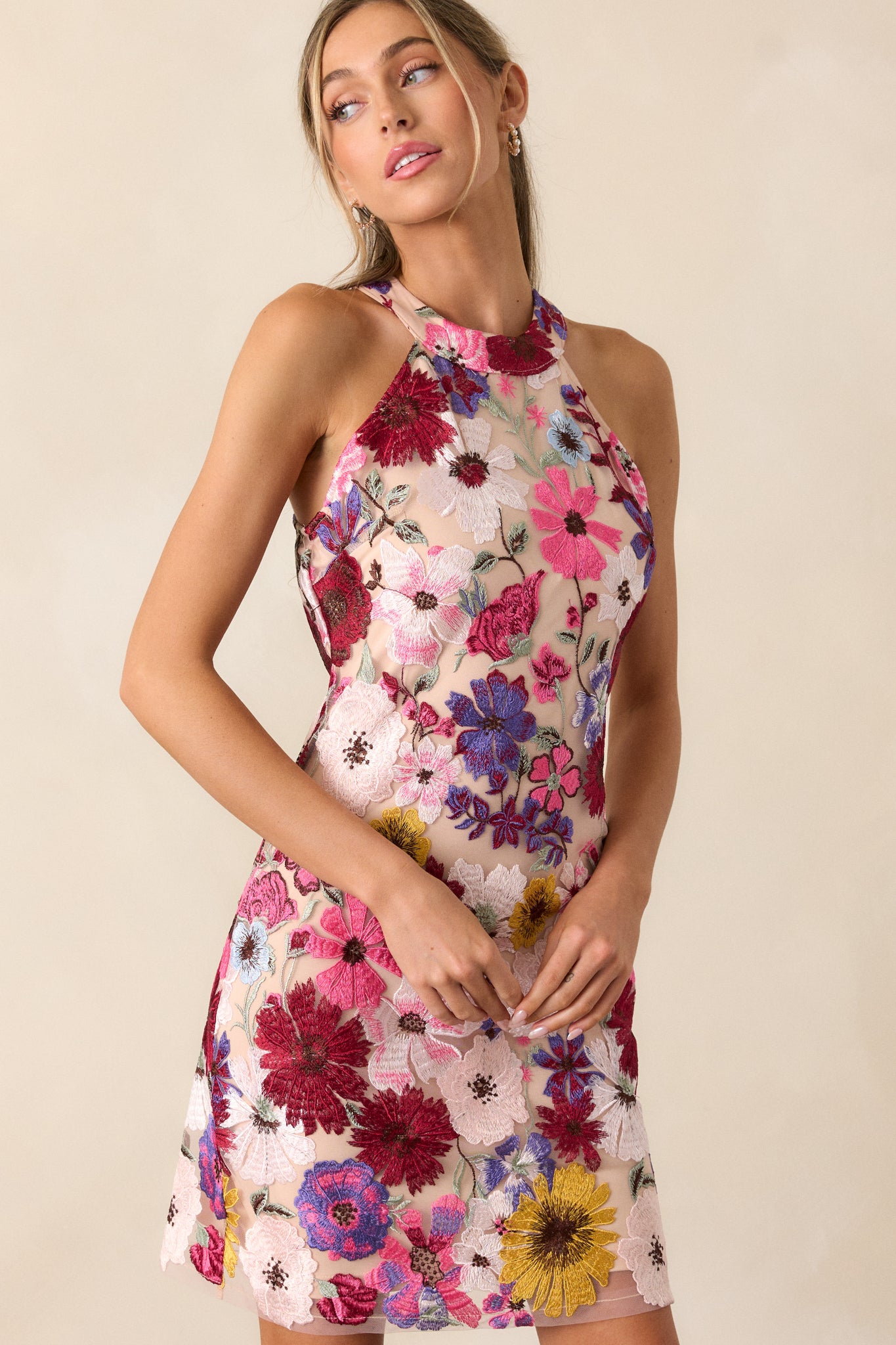 Side view of the dress, showcasing the fitted bodycon design and the intricate floral embroidery along the side.