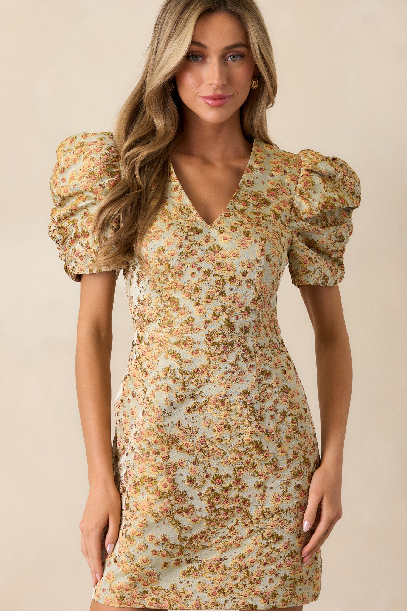 Close-up of the short puff sleeves on the honey dress, showing the delicate floral detailing and the fitted structure of the dress.